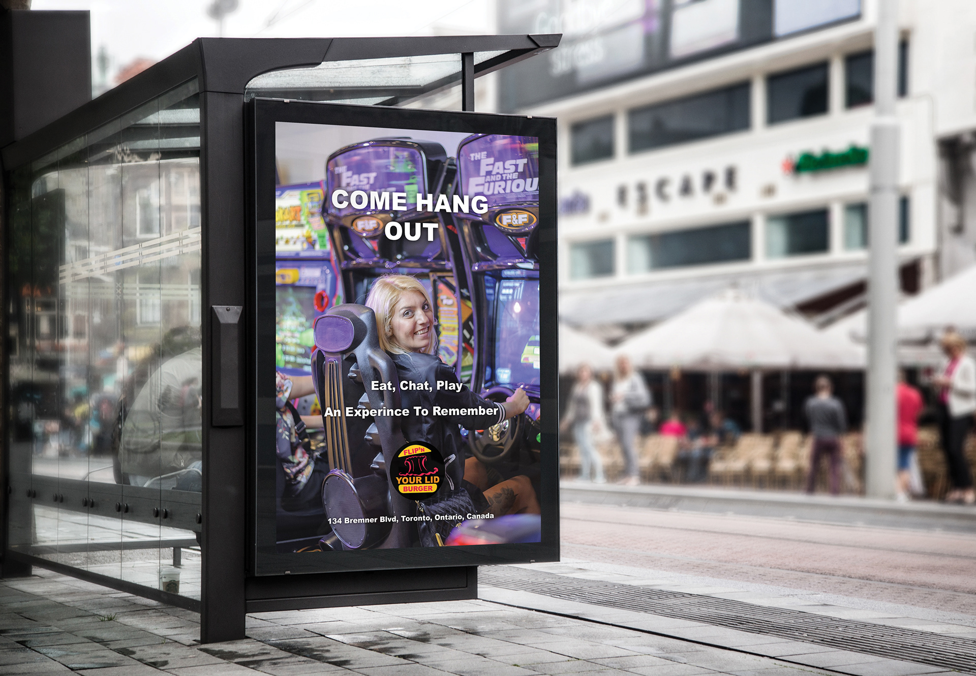 In this image is an advertisement that will be placed at the bus shelter where it shows a female playing a video game with someone at the restaurant. The words Come Hang Out, Eat, Chat, Play, An Experience To Remember and the location of the restaurant all in a white colour. The Flip'N Your Lid Burger logo is located at the bottom of the advertisement, but above the restaurant's street location in the ad.