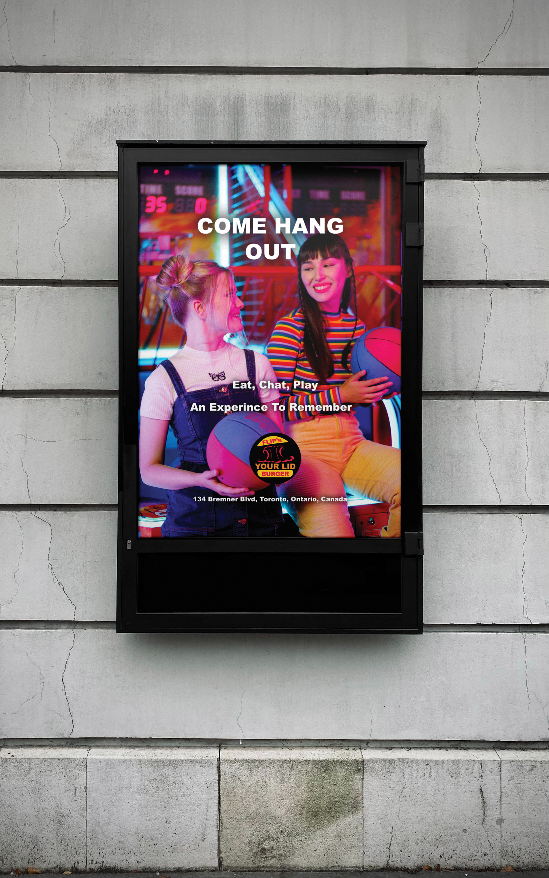 In this image is an advertisement where two female friends are chatting and holding a basketball where they are also playing a game at the restaurant. The words Come Hang Out, Eat, Chat, Play, An Experience To Remember and the location of the restaurant all in a white colour. The Flip'N Your Lid Burger logo is located at the bottom of the advertisement, but above the restaurant's street location in the ad.