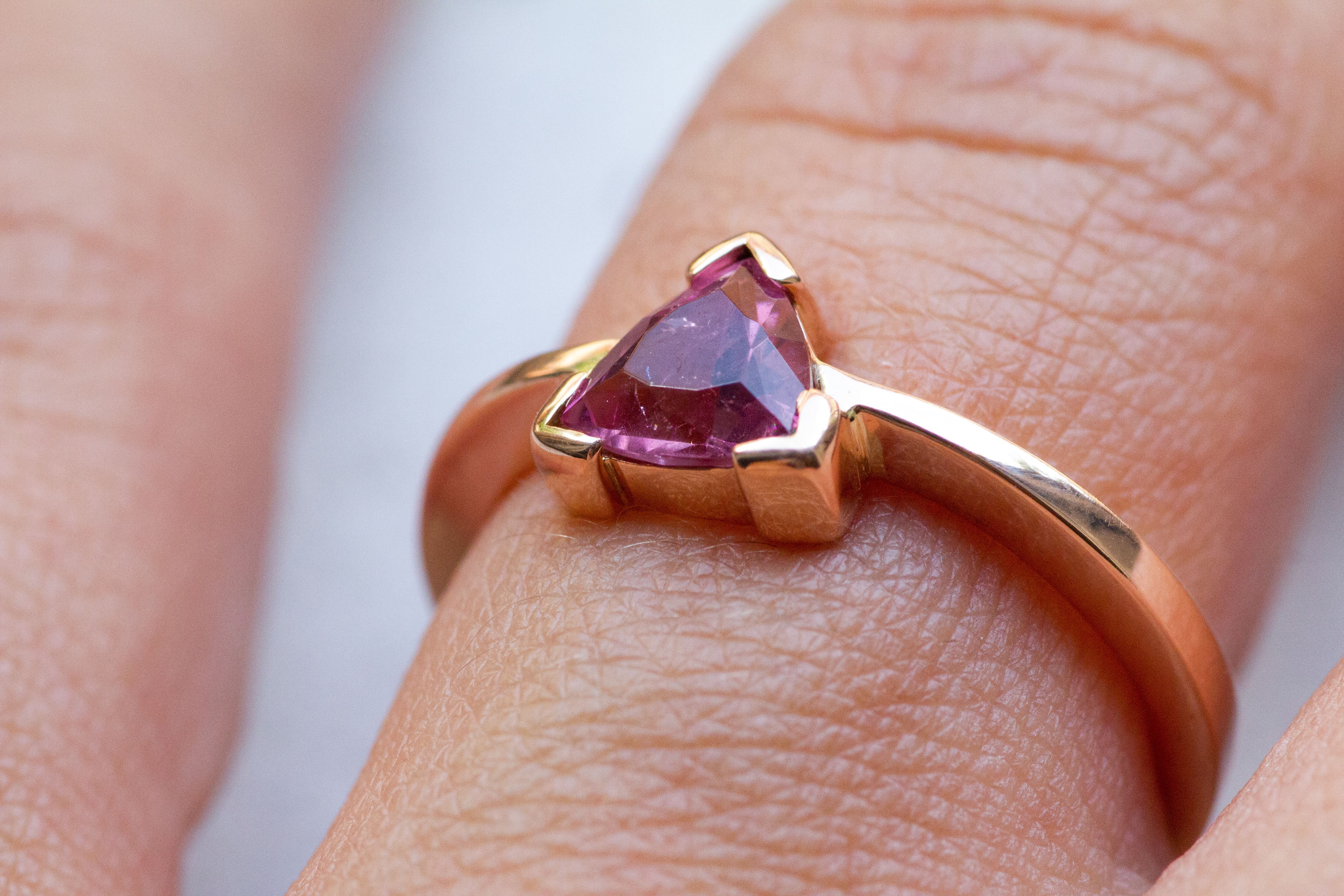 Rosè gold ring with a natural trillion cut pink tourmaline.