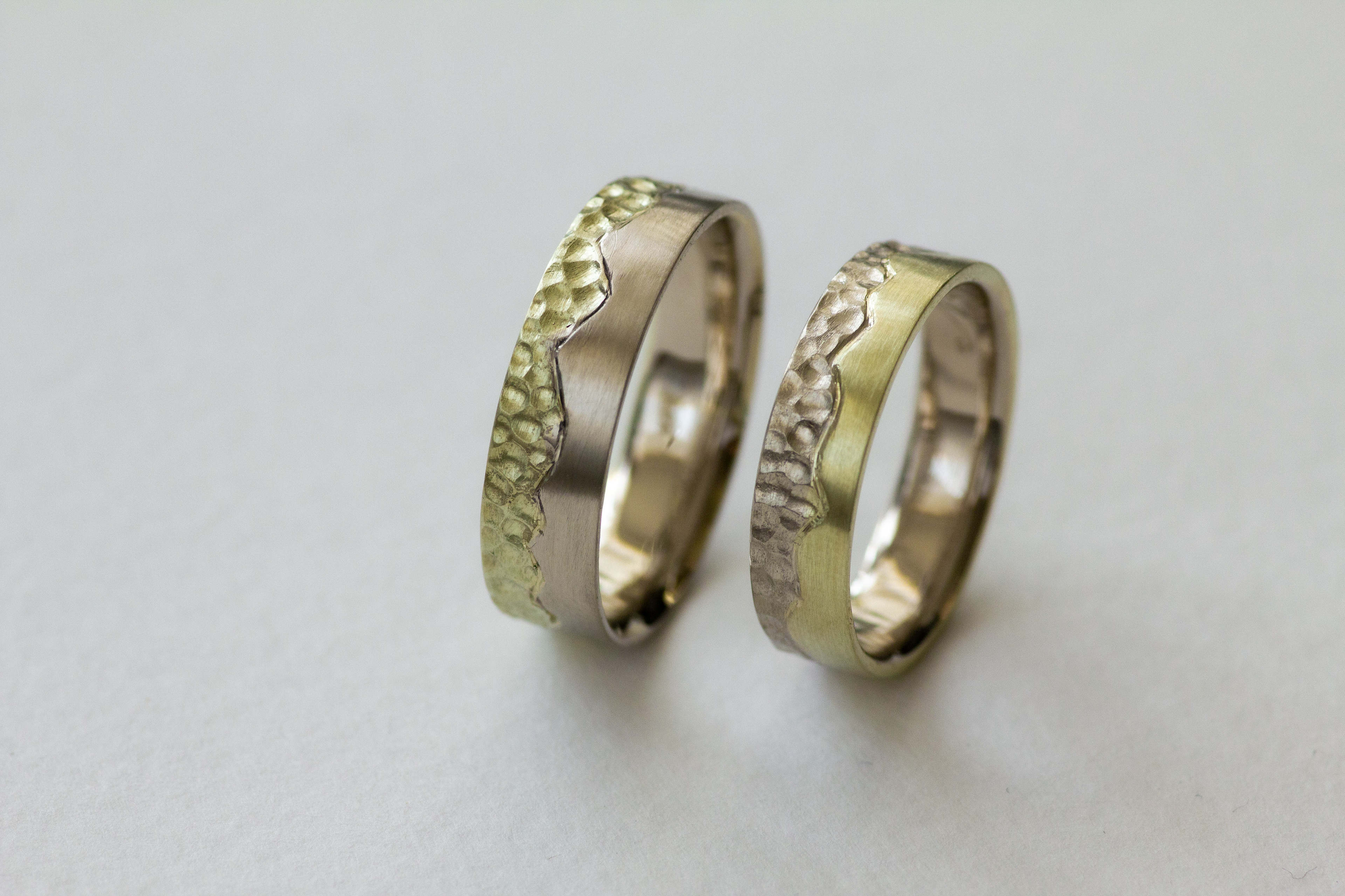 K&M. White and greenish gold. Textured and satinated. Engraved. 