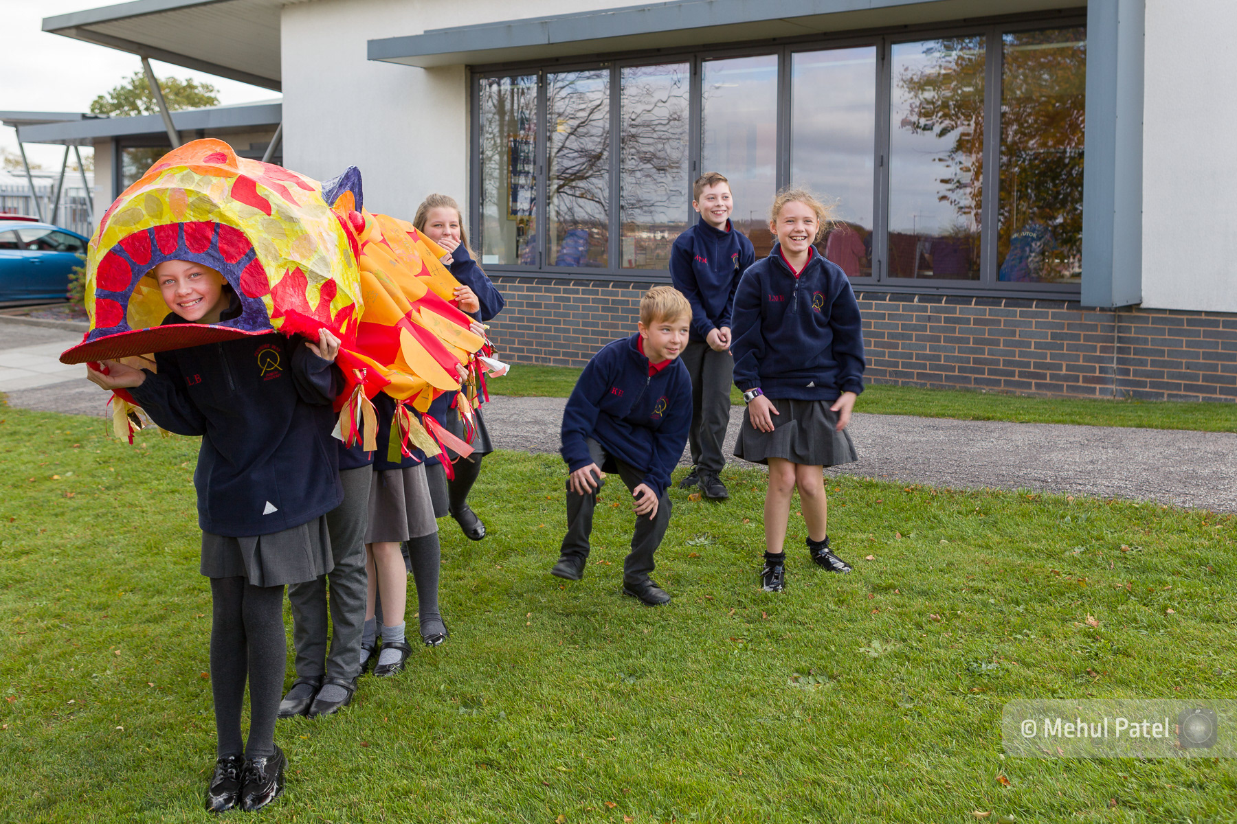 School children showing their art creation. Published in client booklet