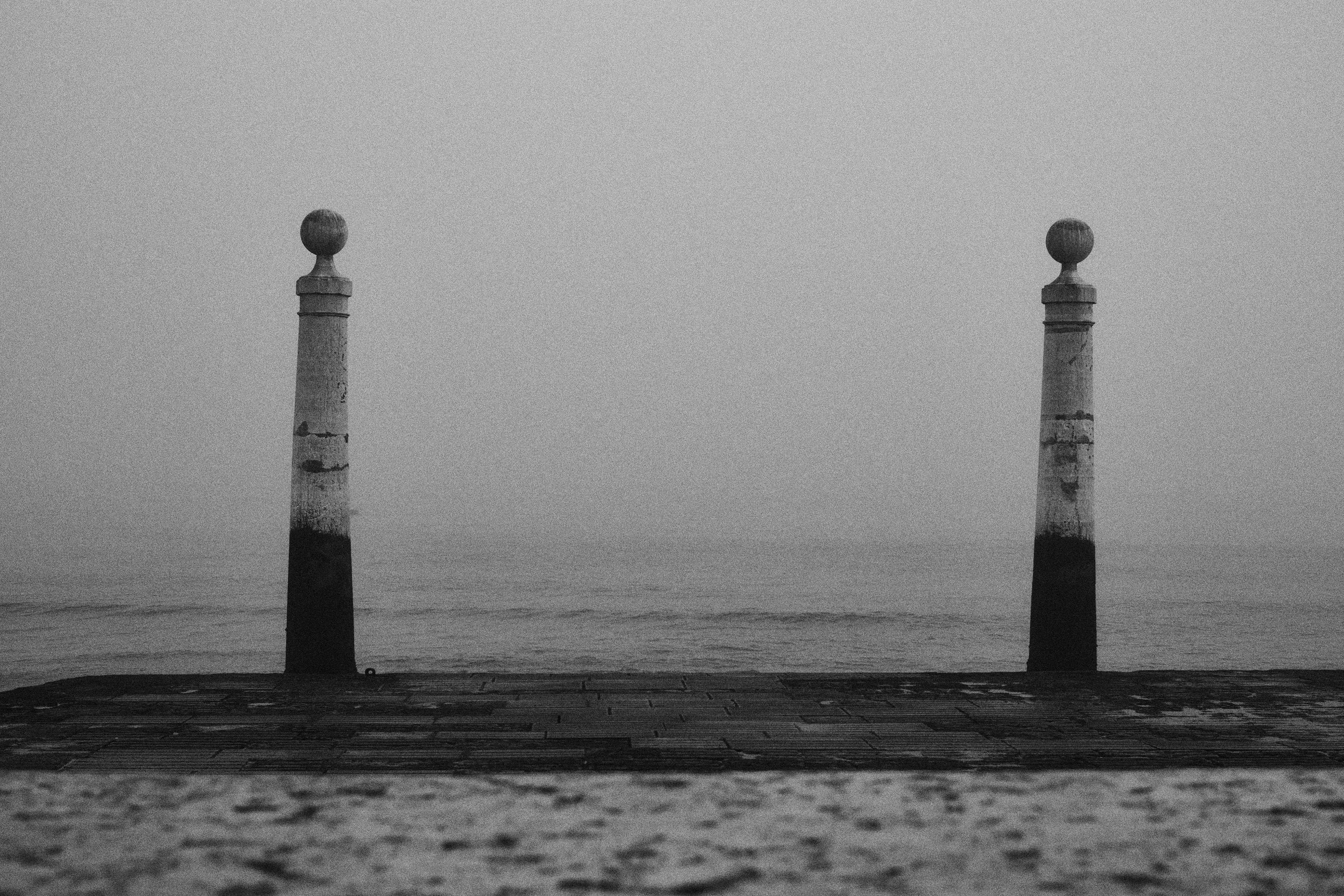 Black and white view of Cais das Colunas in the fog in Lisbon