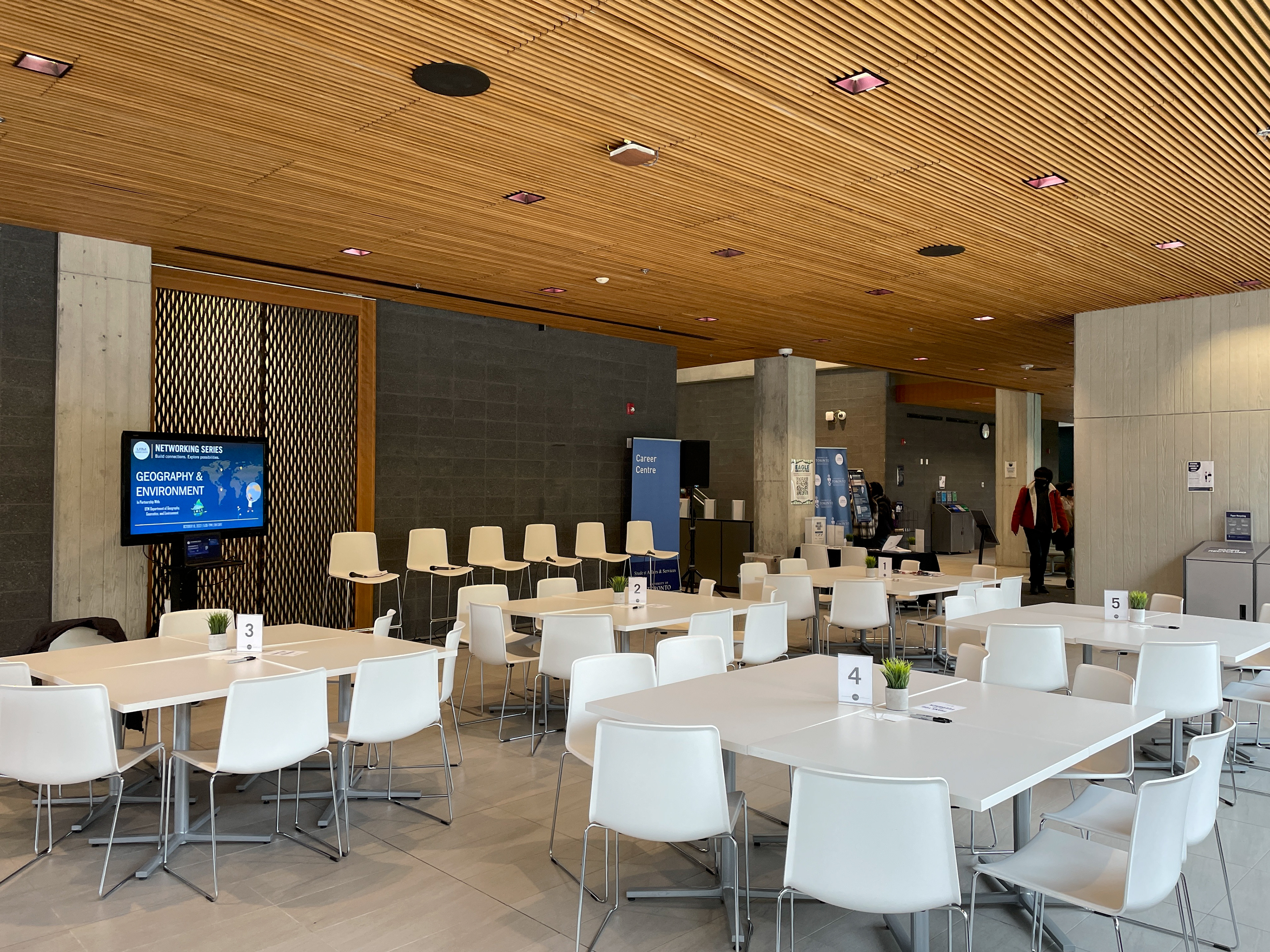 View 1: Networking Event Set-Up with Event Slide-Deck Cover on the Screen (left)