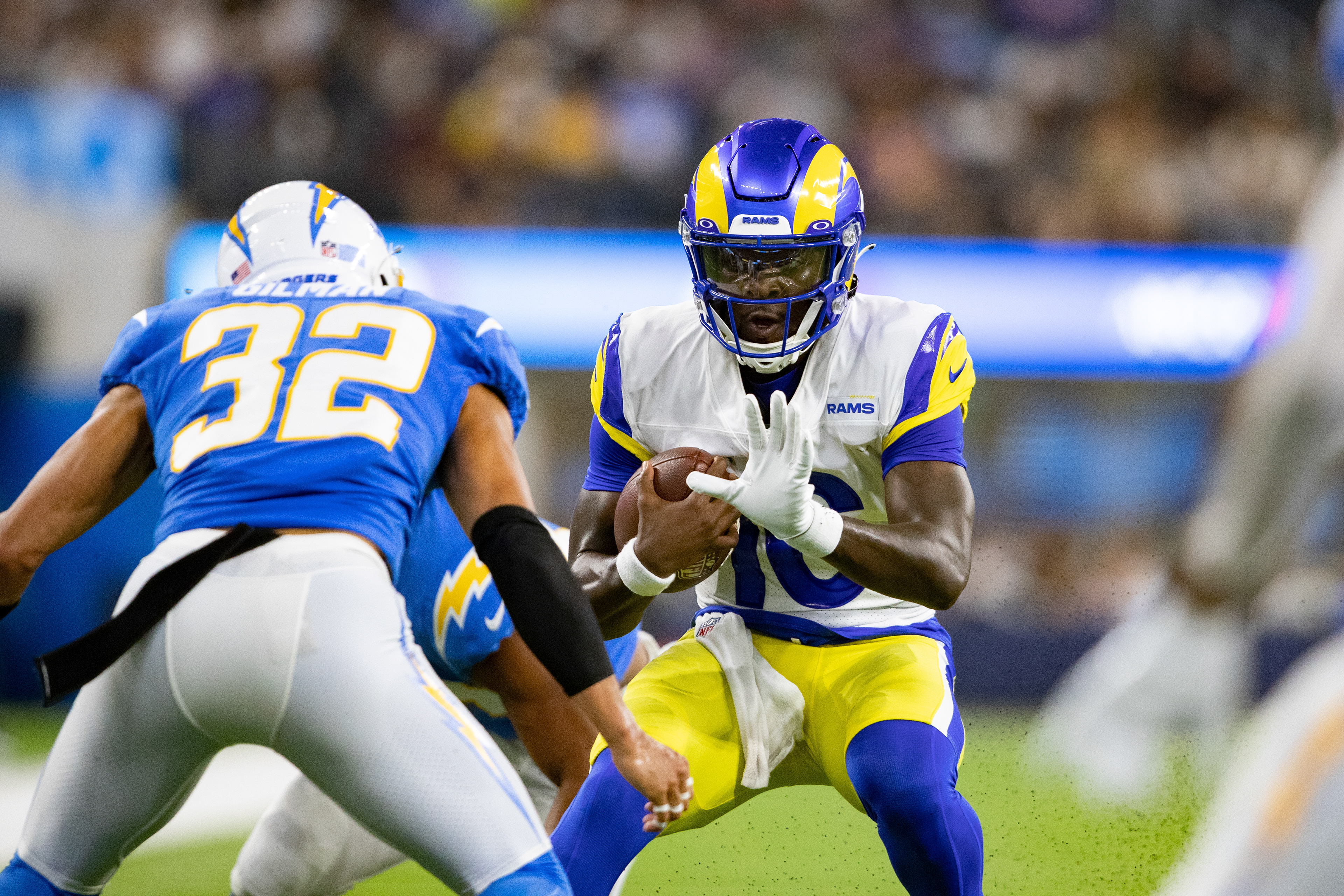 Los Angeles Rams quarterback Bryce Perkins protects the ball during a pre-season game against the Los Angeles Chargers.