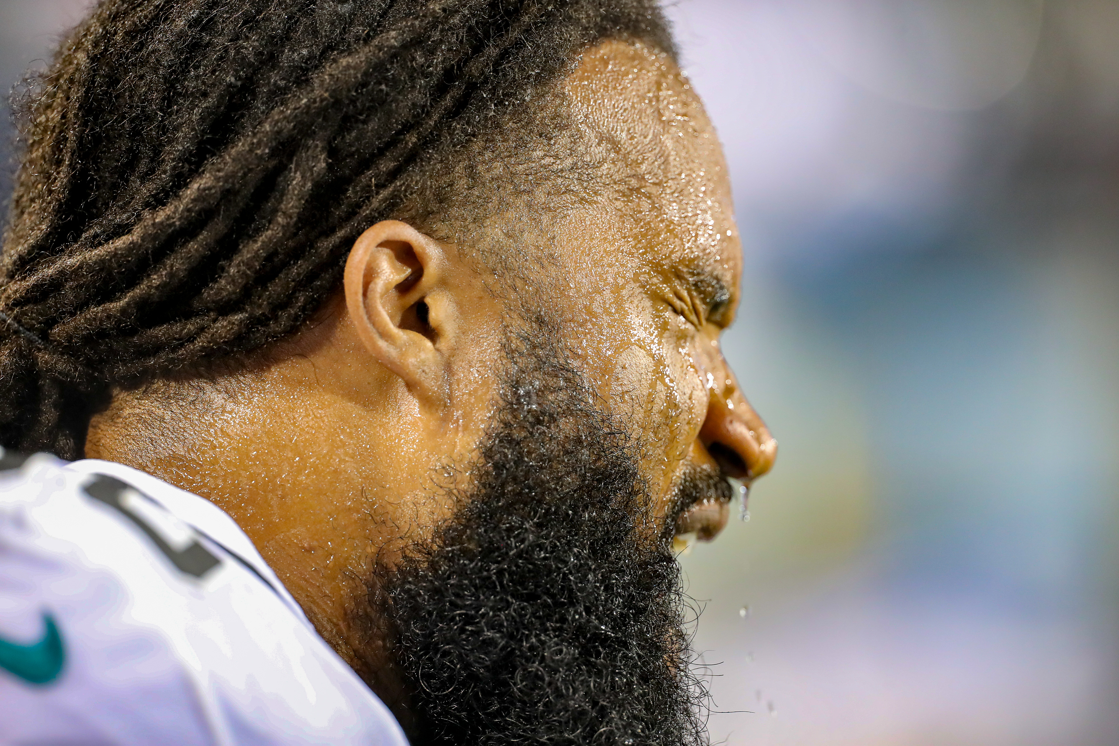 A Jacksonville Jaguars player splashes his face with water during the game. 