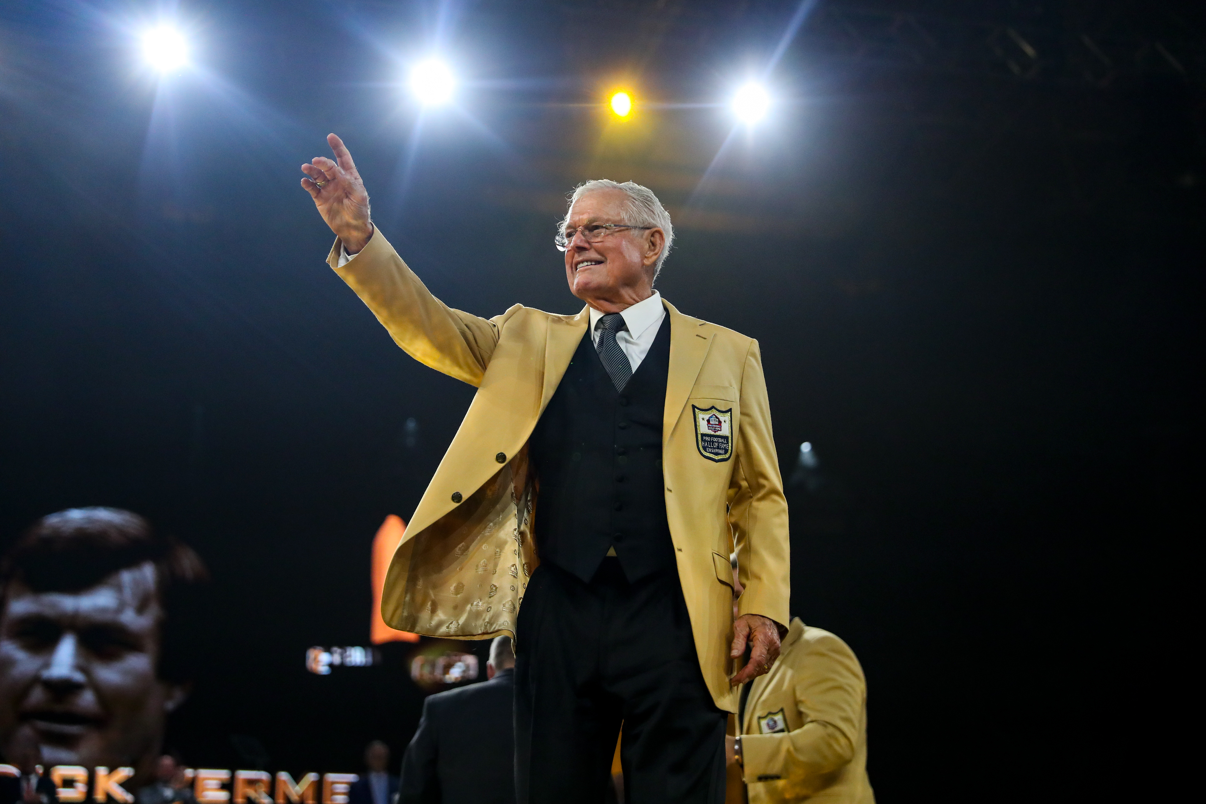 2022 Pro Football Hall of Fame Enshrinee Dick Vermeil gestures to his family.