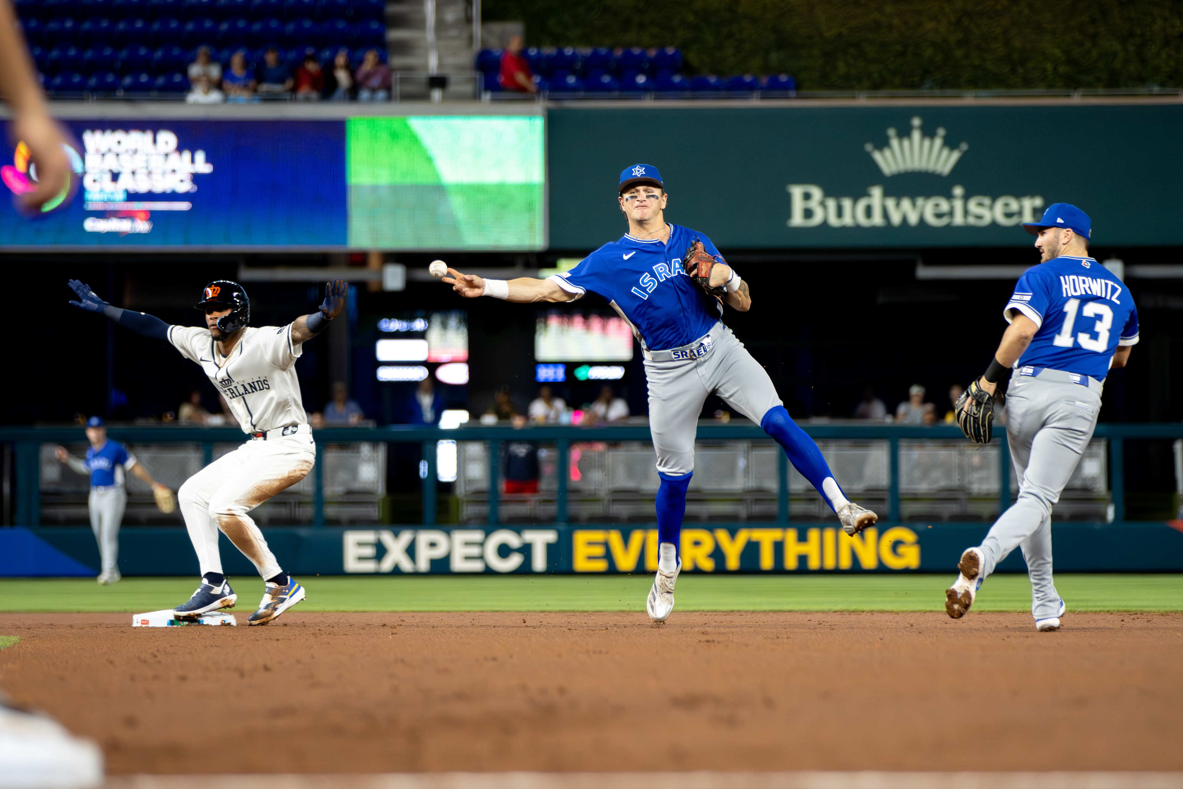 Team Israel shortstop Cole Carrigg (8) attempts to make a jumping throw to second base during a game in Pool D of the World Baseball Classic on March 10, 2026, at LoanDepot Park in Miami, FL (Brody Shuffler/Isreal Baseball Americas)