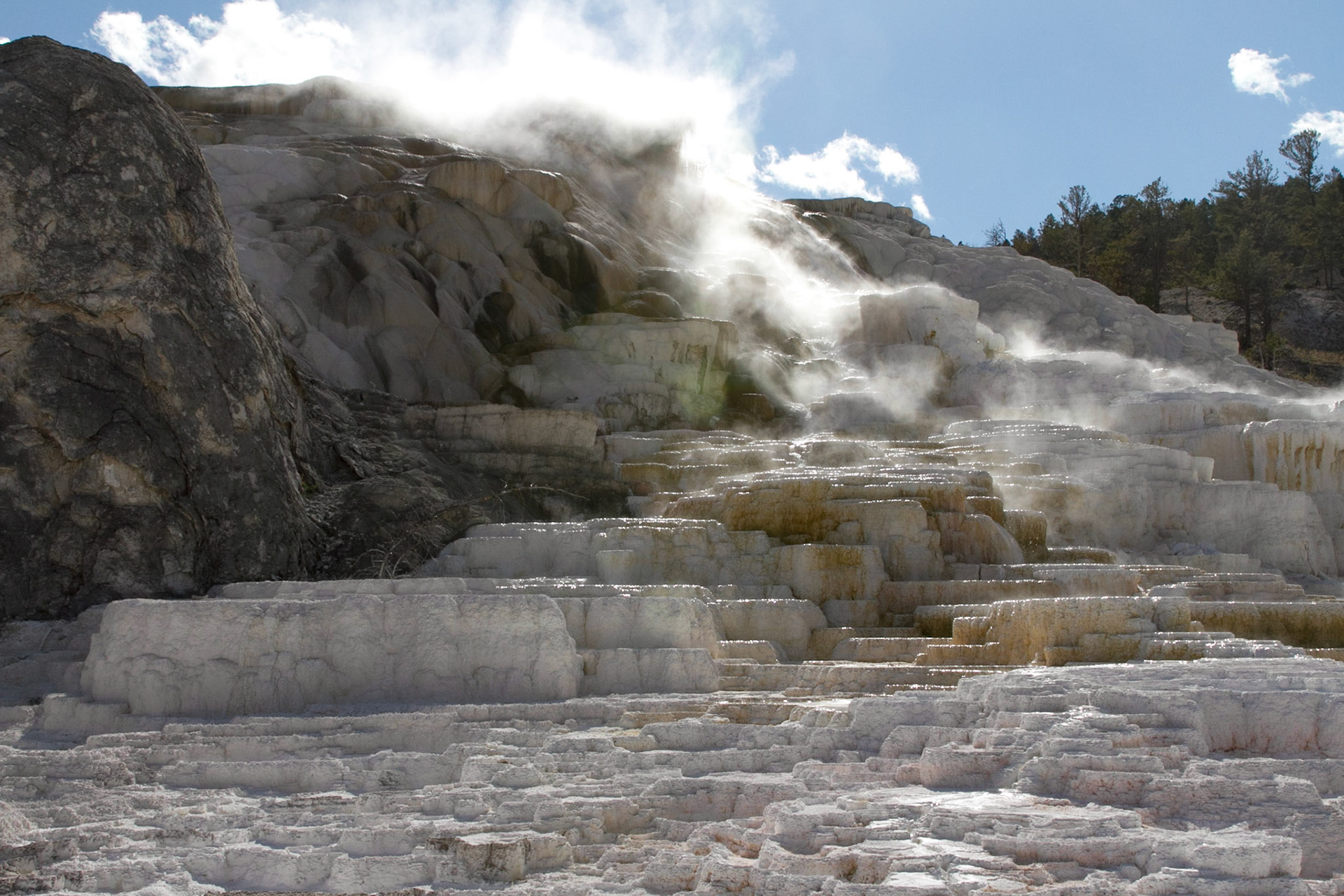 Mammoth Hot Springs is a large complex of hot springs on a hill of travertine in Yellowstone National Park adjacent to Fort Yellowstone and the Mammoth Hot Springs Historic District.