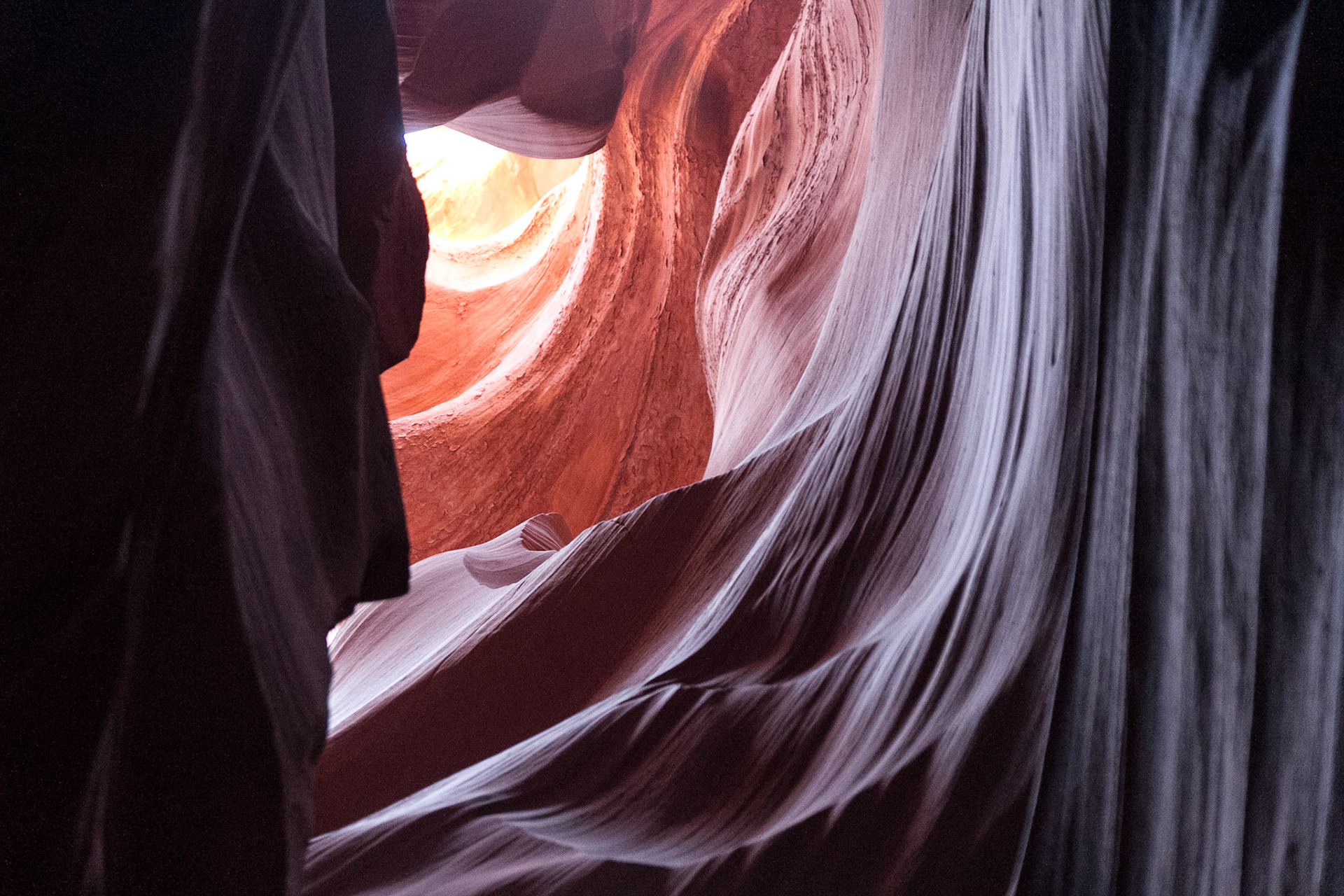 Antelope Canyon is the most-visited and most-photographed slot canyon in the American Southwest. It is located on Navajo land near Page, Arizona. Antelope Canyon includes two separate, photogenic slot canyon sections, referred to individually as Upper Antelope Canyon or The Crack; and Lower Antelope Canyon or The Corkscrew.The Navajo name for Upper Antelope Canyon is Tsé bighánílíní, which means "the place where water runs through rocks."