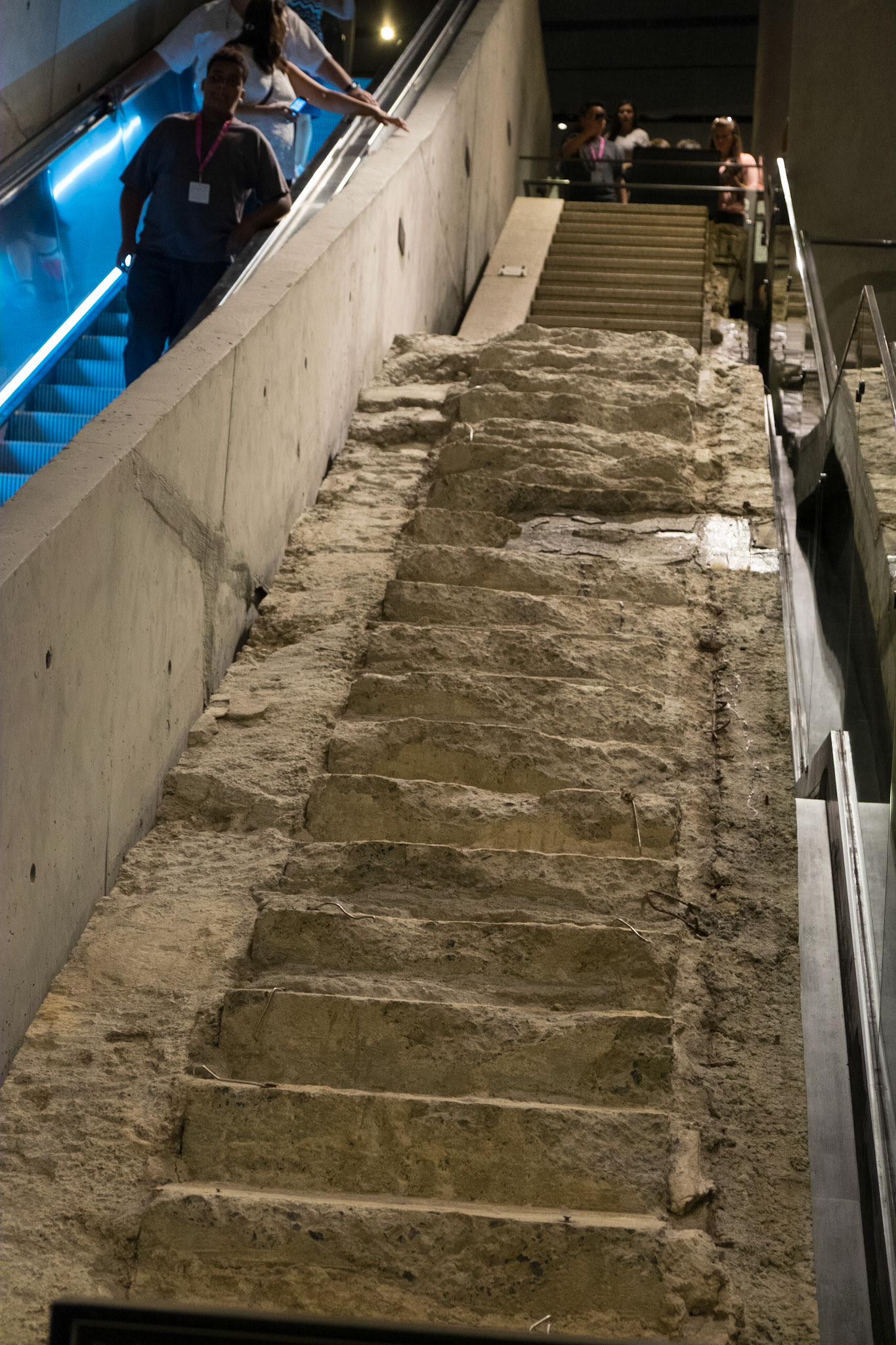 During the attacks of September 11, 2001, this stairway served as a vital route to safety for many people. The stairs were mostly intact immediately after 9/11, but they were significantly damaged during the nine-month recovery period. The stairway provides a powerful reference to the survivors’ story as well as a commemoration of the recovery period. It is also the sole vestige above ground of the World Trade Center,The stair remnant originally weighed 175 tons and stood 22 feet tall.