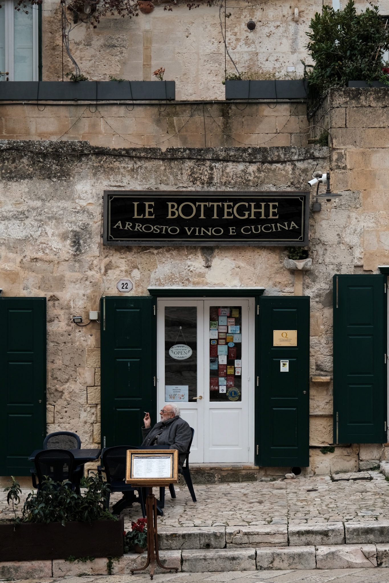 Le Botteghe, quietly waiting: Warmth behind green shutters.