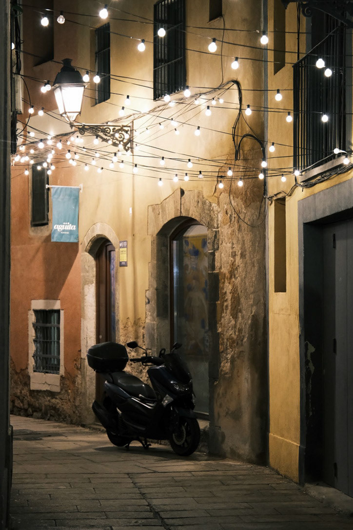 Evening lights and scooter Barcelona’s charm: half stillness, half spark.