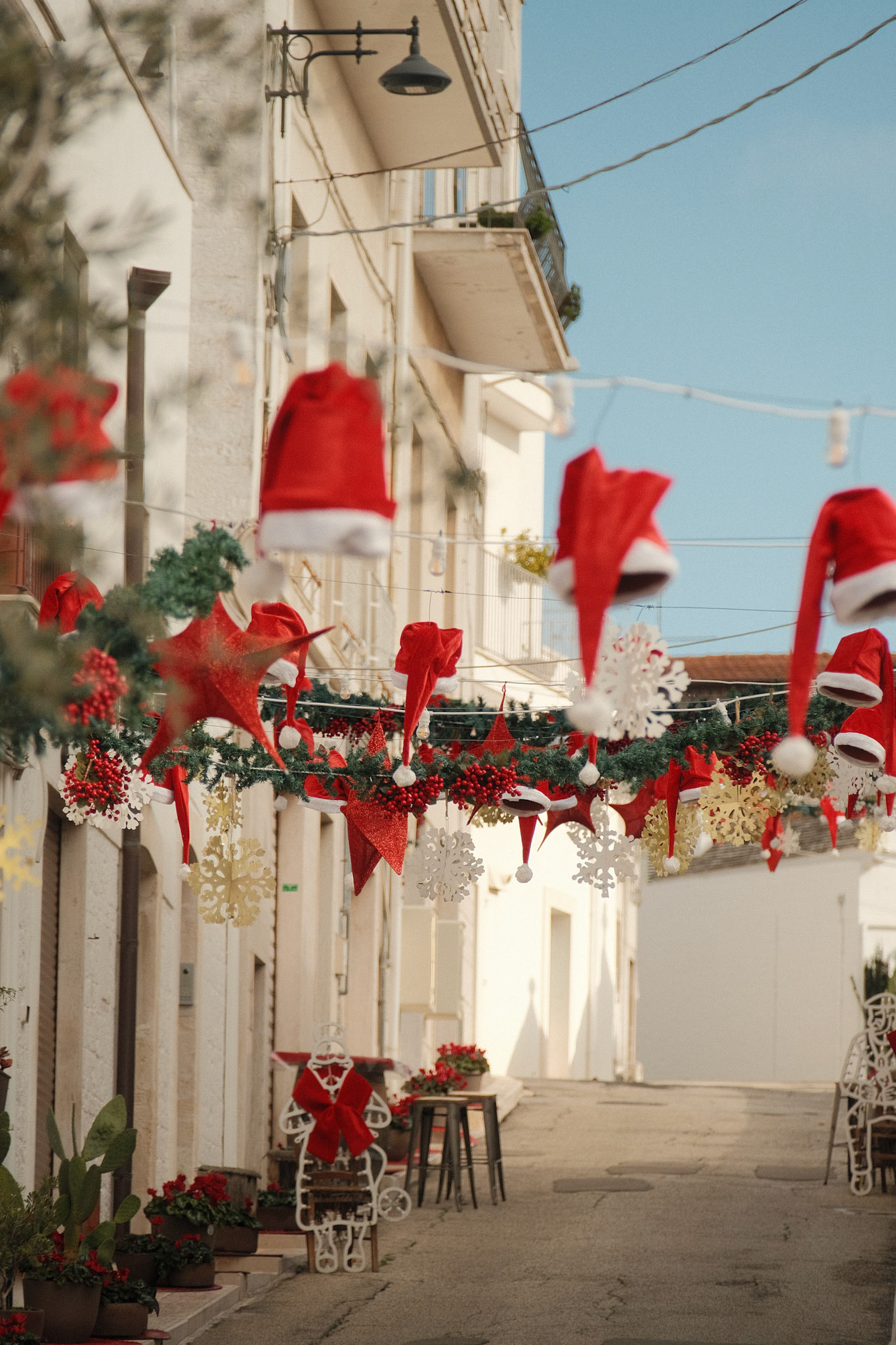Red ribbons sway with laughter in the wind.