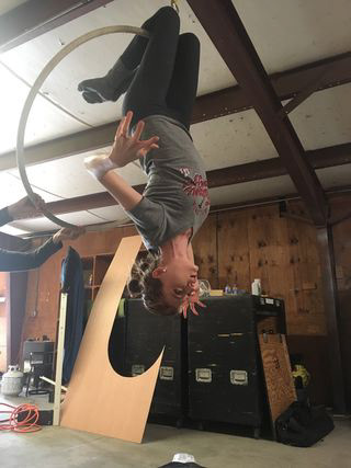 Emily Alsdorf hangs upside down doing a test for the monster in the film
