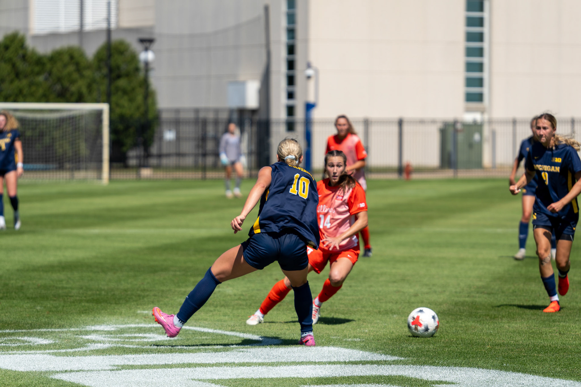 Bella Zanoni, junior defender, dribbles past Michigan forward Melisa Kekic and defender Campbell Jewell at Demirjian Park on Sunday. Illinois fell to Michigan 2-0 in the Big Ten contest.