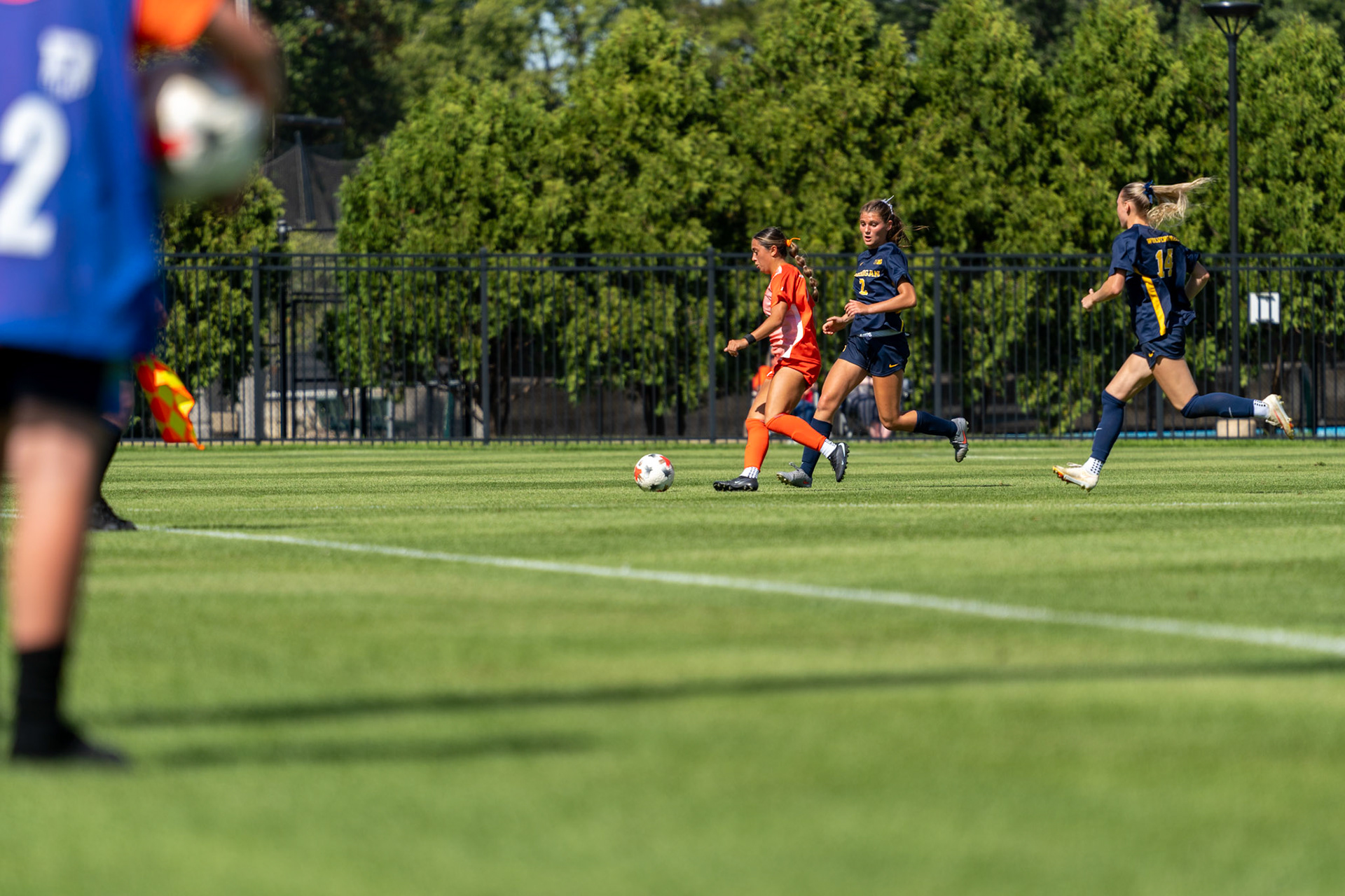 Alyssa White, junior midfielder, dribbles past Michigan defender Anabelle Egeland and forward Ella Jablinskey at Demirjian Park on Sunday. Illinois fell to Michigan 2-0 in the Big Ten matchup.