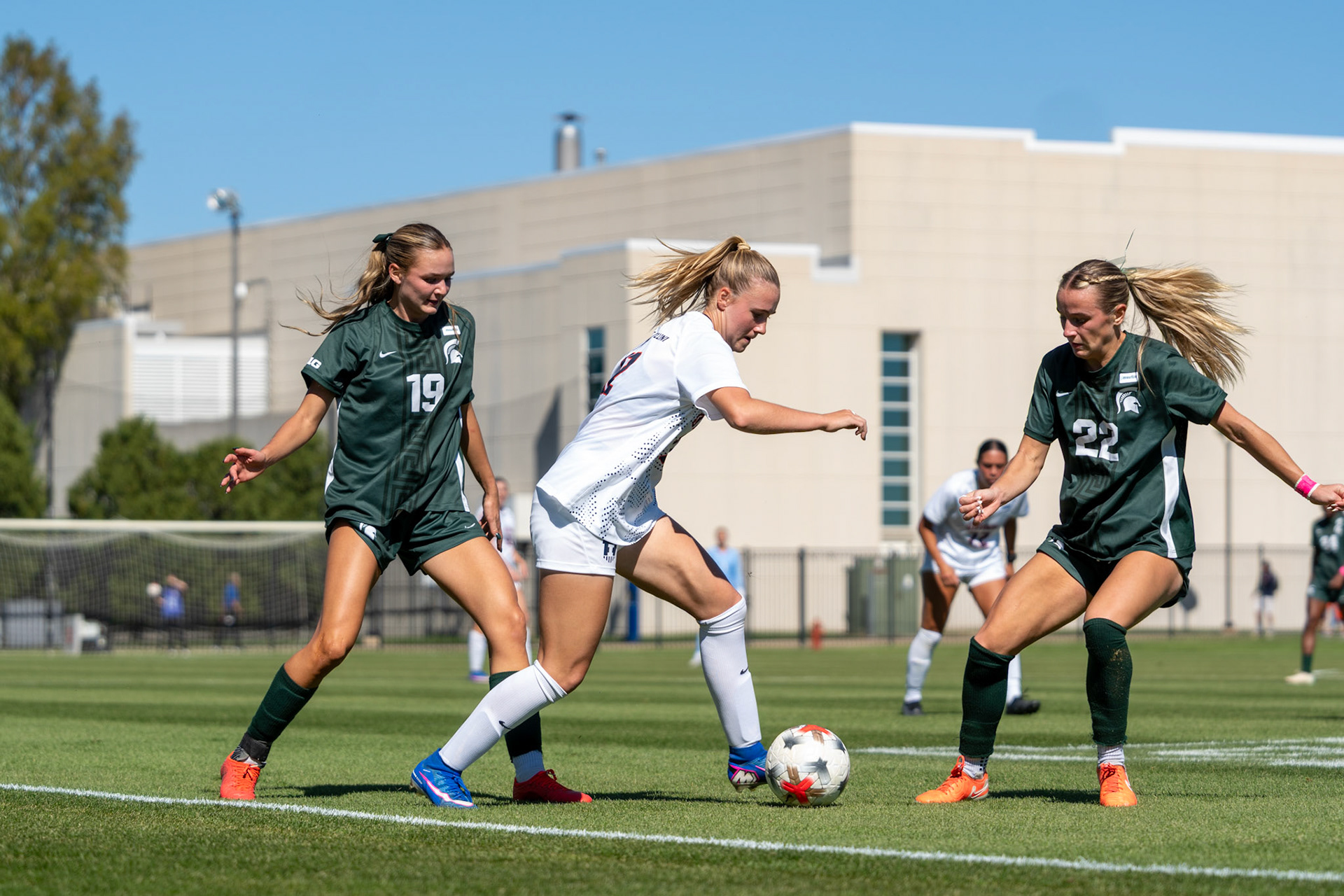 Sophia McMillan, freshman forward/midfielder, weaves between Michigan State midfielder Emerson Sargeant and midfielder Ella Janz at Demirjian Park on Oct. 4, 2026. Illinois fell 1-0 to No. 2 Michigan State after a late goal in the 85th minute.