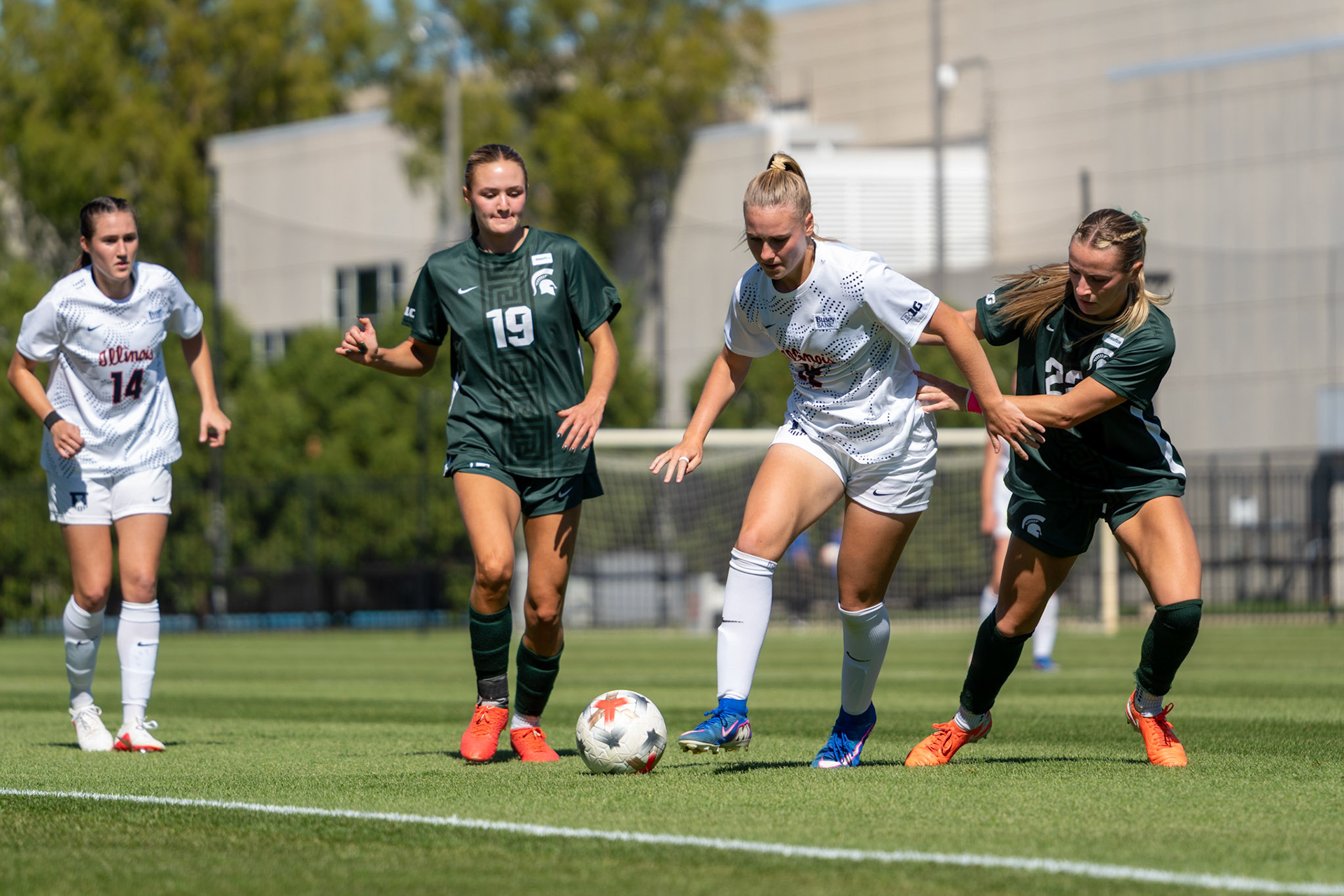 Sophia McMillan, freshman forward/midfielder, weaves between Michigan State midfielder Emerson Sargeant and midfielder Ella Janz at Demirjian Park on Oct. 4, 2026. Illinois fell 1-0 to No. 2 Michigan State after a late goal in the 85th minute.