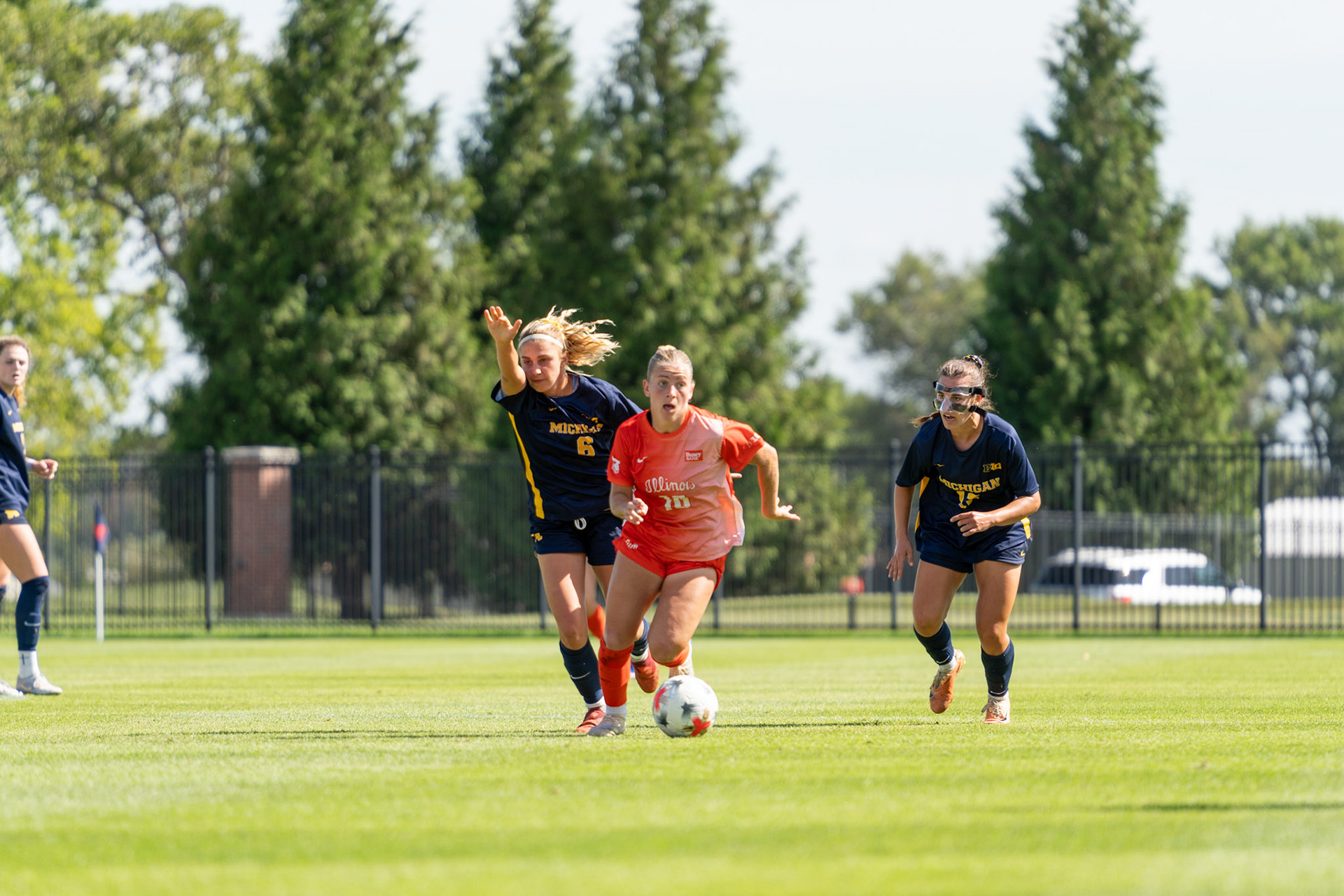Ashley Stellon, fifth-year midfielder, gets past Michigan midfielder Adi Walick and midfielder Rylie McKinney at Demirjian Park on Sunday. Illinois fell to Michigan 2-0 in the Big Ten contest.