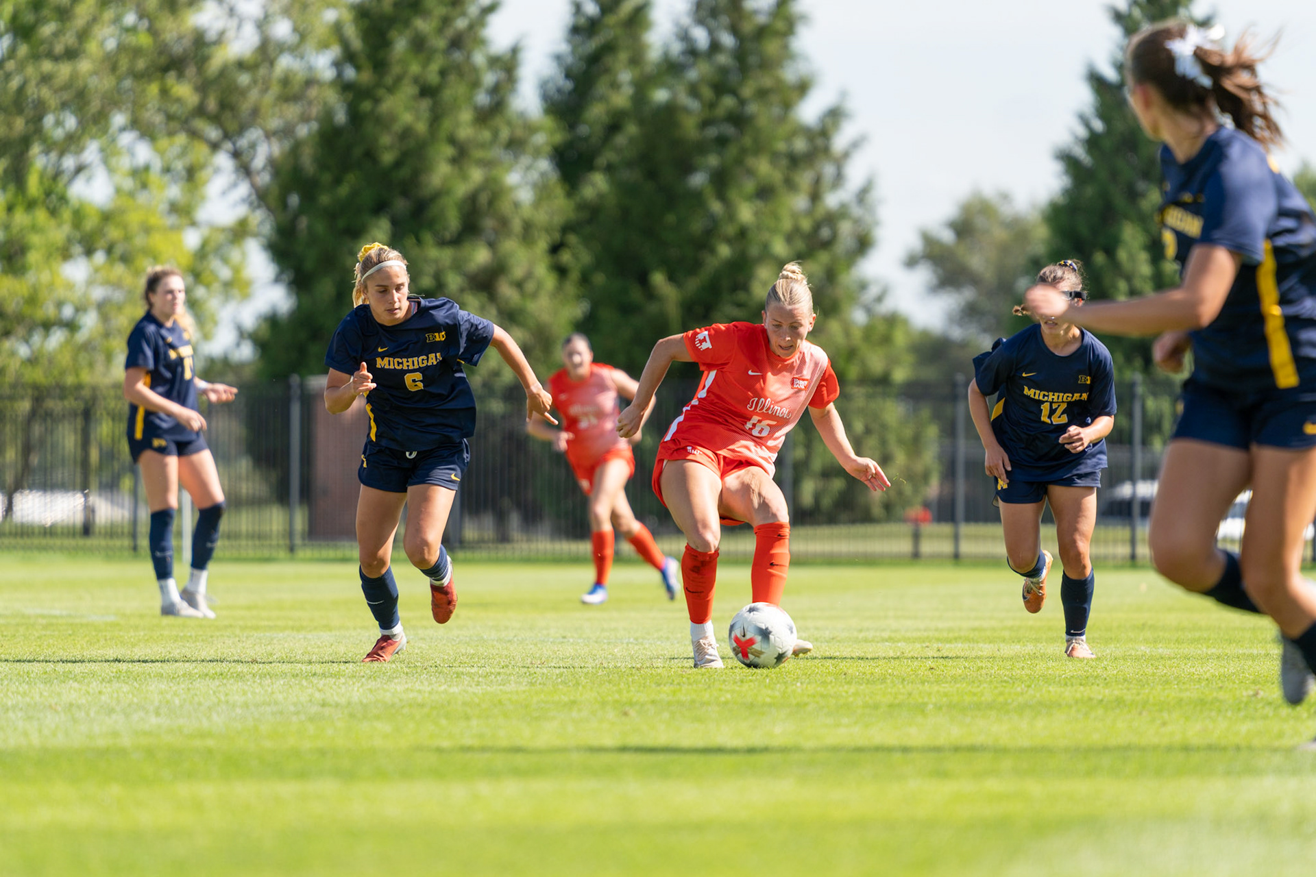 Ashley Stellon, fifth-year midfielder, gets past Michigan midfielder Adi Walick and midfielder Rylie McKinney at Demirjian Park on Sunday. Illinois fell to Michigan 2-0 in the Big Ten contest.