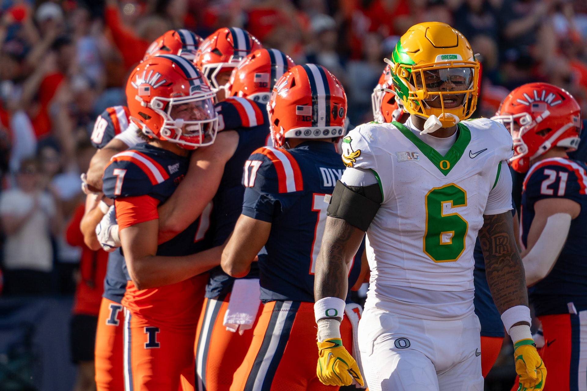 Christian Abney, senior tight end, celebrates with teammates including quarterback Michael Clayton II after hauling in a touchdown reception at Gies Memorial Stadium on Oct. 24, 2026. The 9-yard score in the third quarter gave Illinois a 14-10 lead over Oregon.