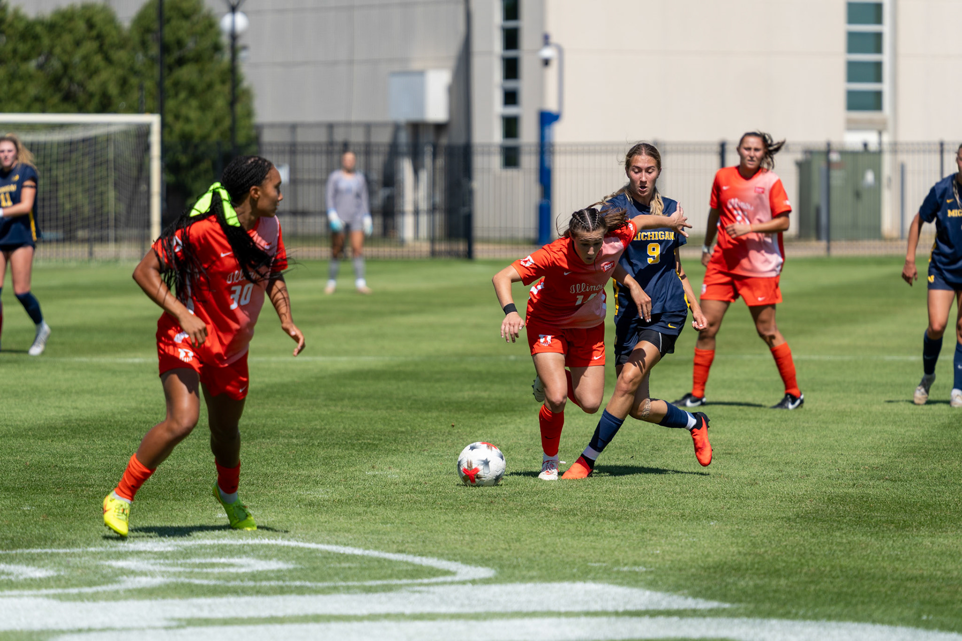 Bella Zanoni, junior defender, dribbles past Michigan forward Melisa Kekic and defender Campbell Jewell at Demirjian Park on Sunday. Illinois fell to Michigan 2-0 in the Big Ten contest.