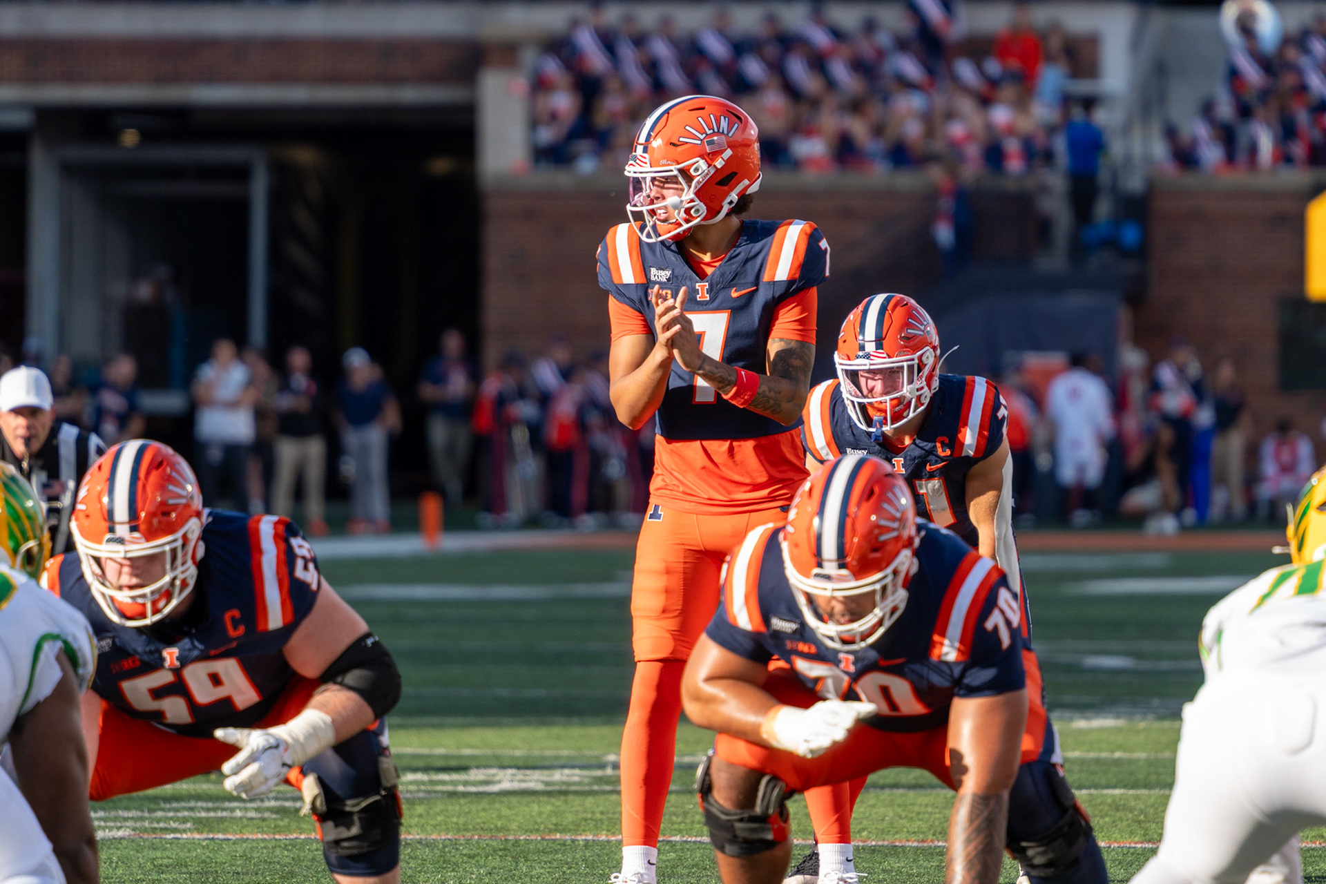 Michael Clayton II calls for the snap before throwing a 9-yard touchdown pass to Christian Abney at Gies Memorial Stadium on Oct. 24, 2026. The score in the third quarter gave Illinois a 14-10 lead over Oregon.