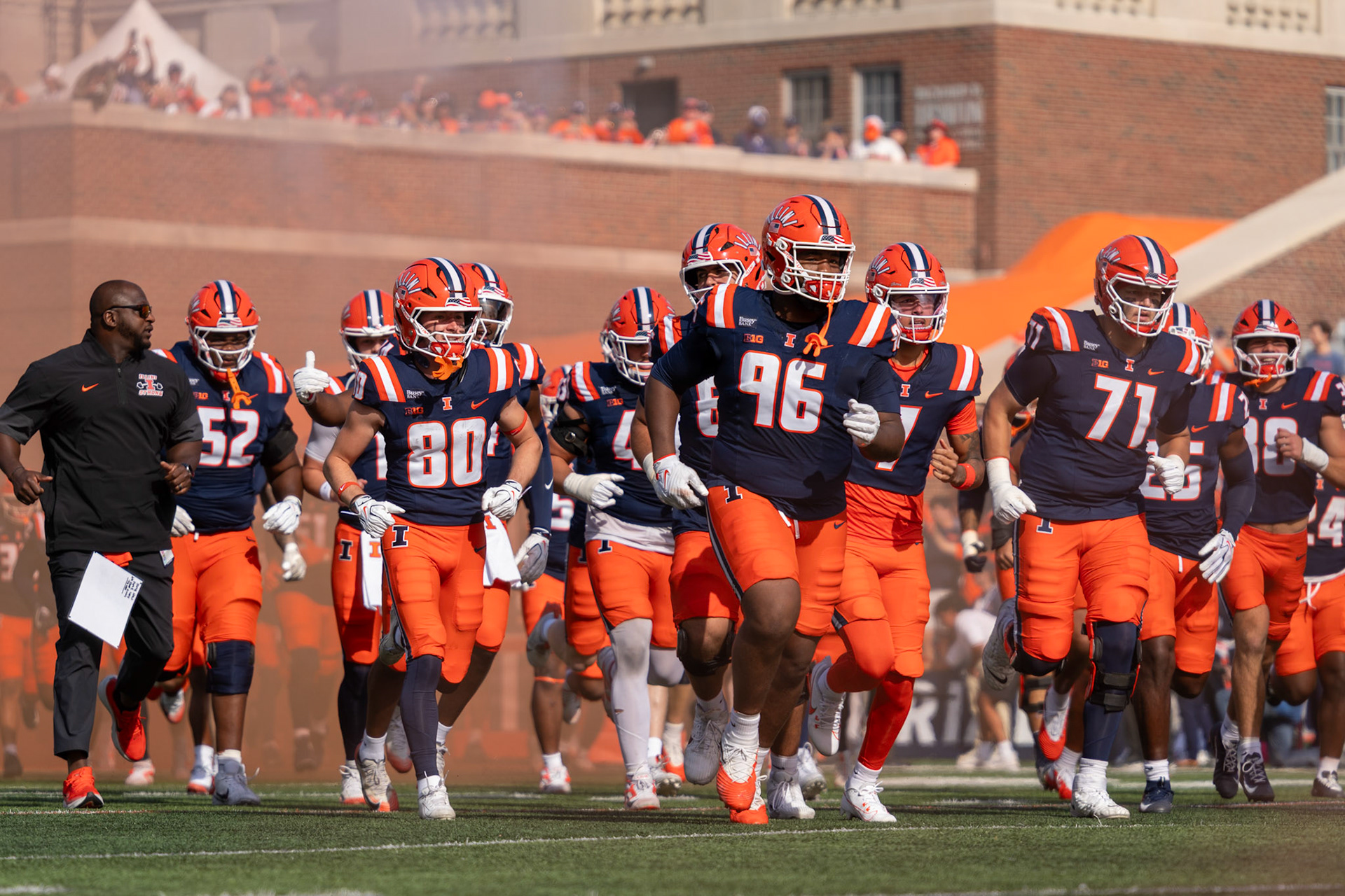 Illinois football players run out of the tunnel before their game against Oregon at Gies Memorial Stadium on Oct. 24, 2026. The Illini defeated the Ducks 21-10 in front of 58,723 fans.