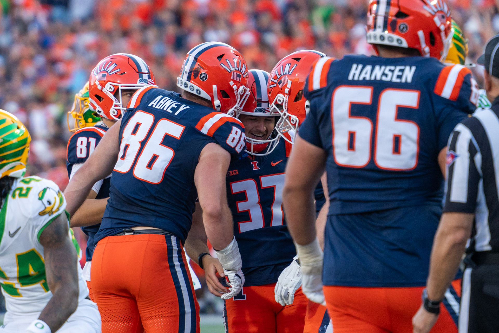Ethan Moczulski, fifth-year kicker, celebrates with Christian Abney, senior tight end, and Brandon Hansen, junior offensive lineman, after converting an extra point to make the score 21-10 at Gies Memorial Stadium on Oct. 24, 2026. The kick capped Illinois’ go-ahead touchdown drive in the fourth quarter.