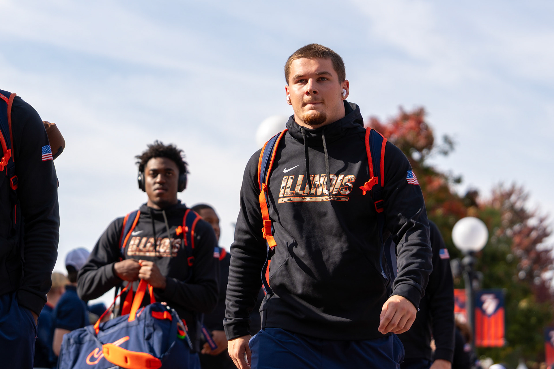 Illinois players walk through Grange Grove during the Illini Walk before their game against Oregon at Gies Memorial Stadium on Oct. 24, 2026. The Illini defeated the Ducks 21-10 in front of 58,723 fans.