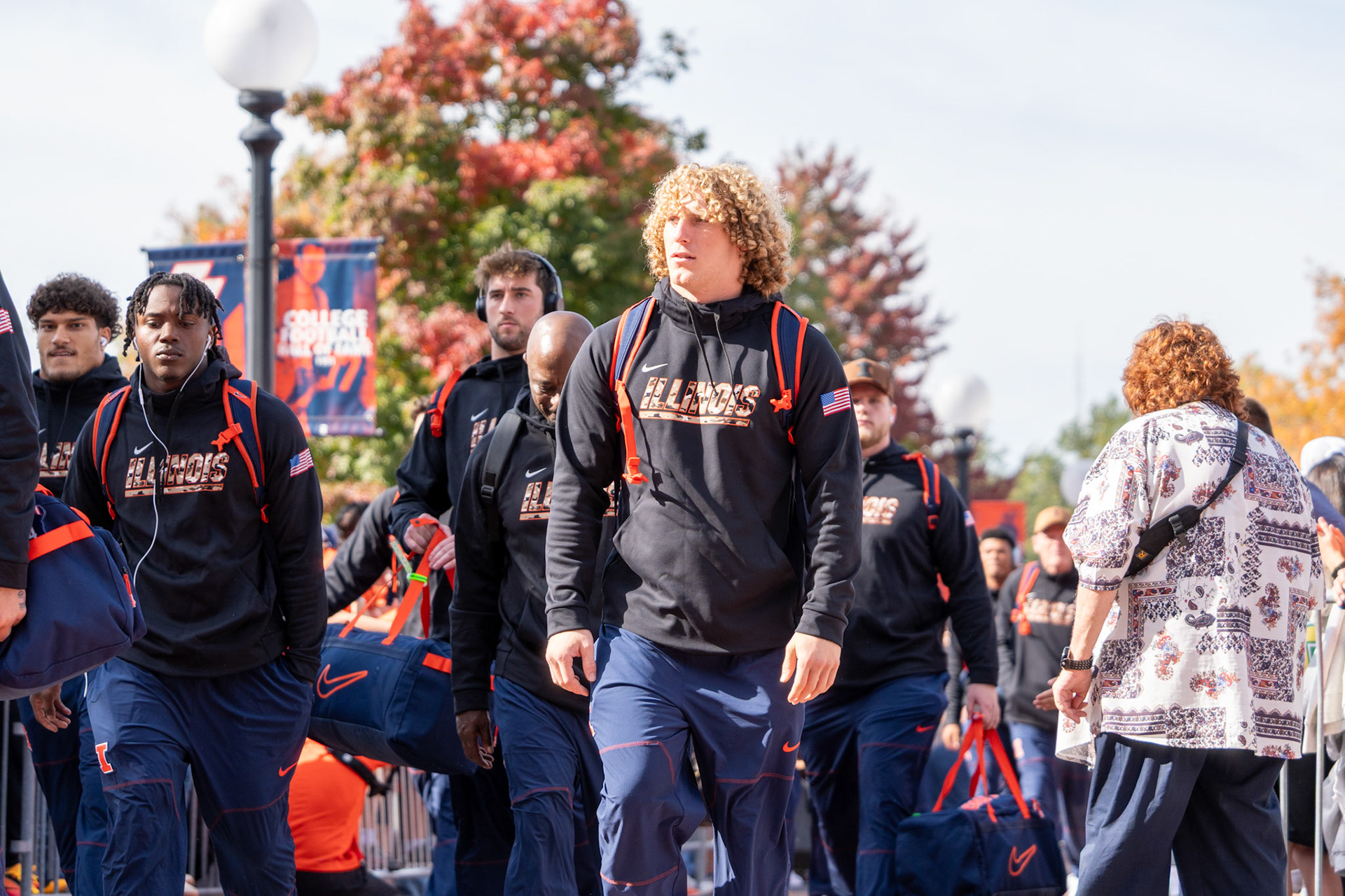 Illinois players walk through Grange Grove during the Illini Walk before their game against Oregon at Gies Memorial Stadium on Oct. 24, 2026. The Illini defeated the Ducks 21-10 in front of 58,723 fans.