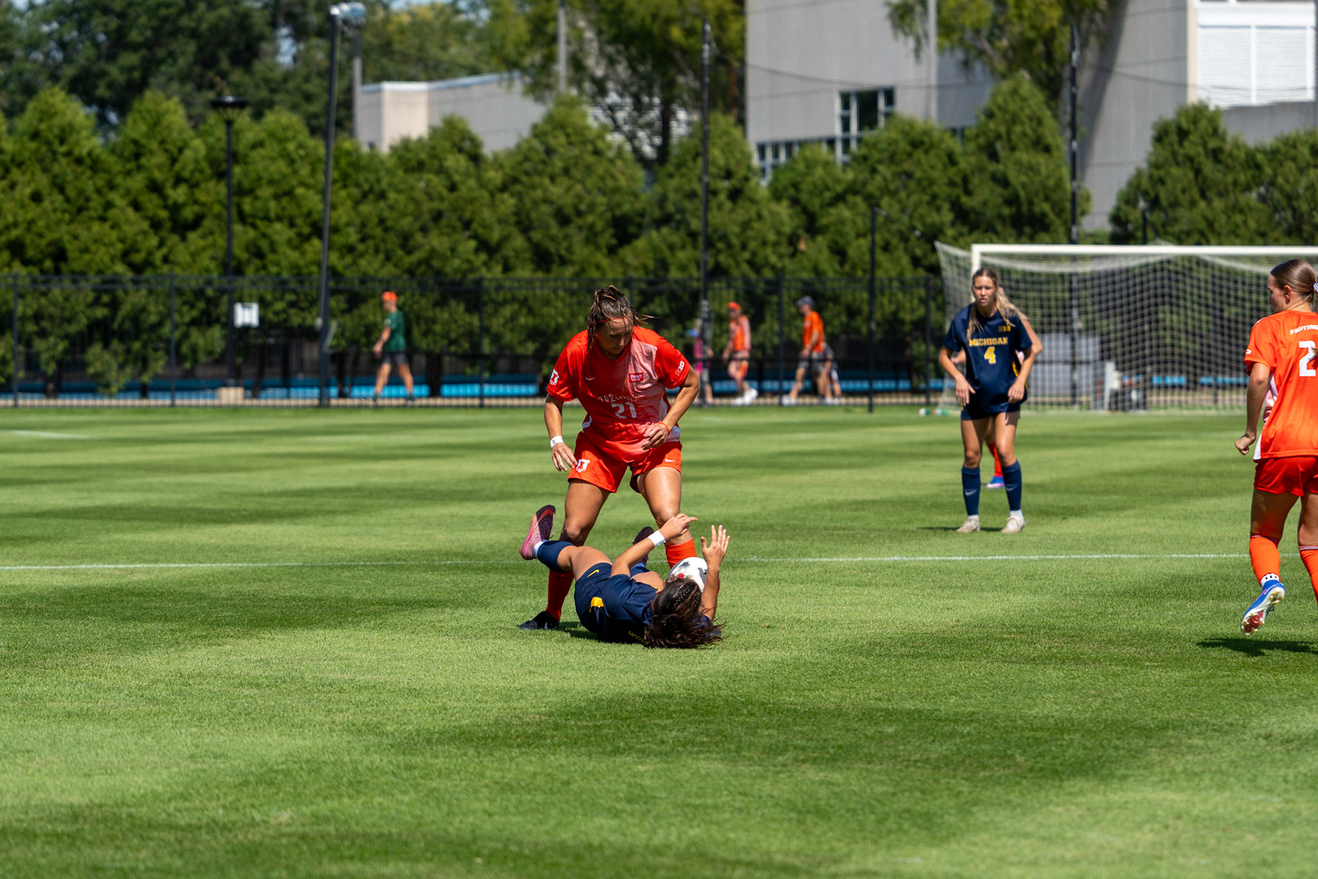 Myra Schneider, senior midfielder, battles for possession against Michigan midfielder Beanie Harshe at Demirjian Park on Sunday. Illinois fell to Michigan 2-0 in the Big Ten matchup.