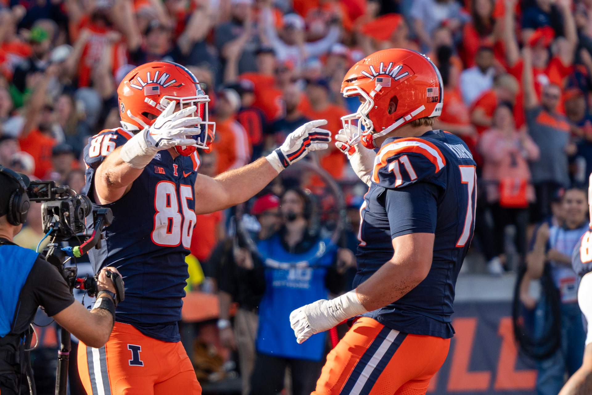Christian Abney, senior tight end, celebrates his touchdown reception with offensive lineman Nathan Knapik at Gies Memorial Stadium on Oct. 24, 2026. The 9-yard score in the third quarter gave Illinois a 14-10 lead over Oregon.