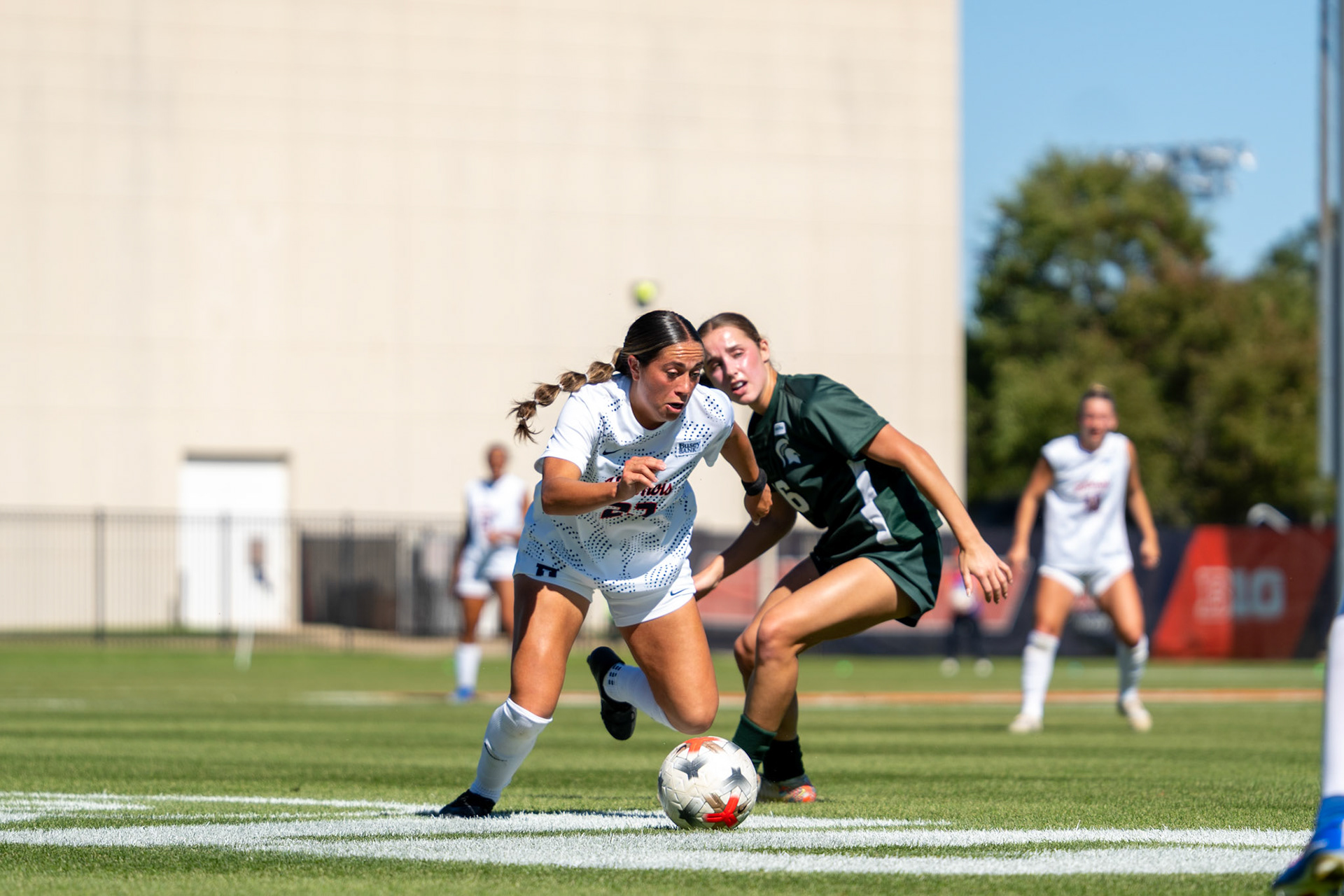 Alyssa White, junior midfielder, dribbles past Michigan State midfielder Kaleigh McPherson at Demirjian Park on Oct. 4, 2026. Illinois fell 1-0 to No. 2 Michigan State after a late goal in the 85th minute.
