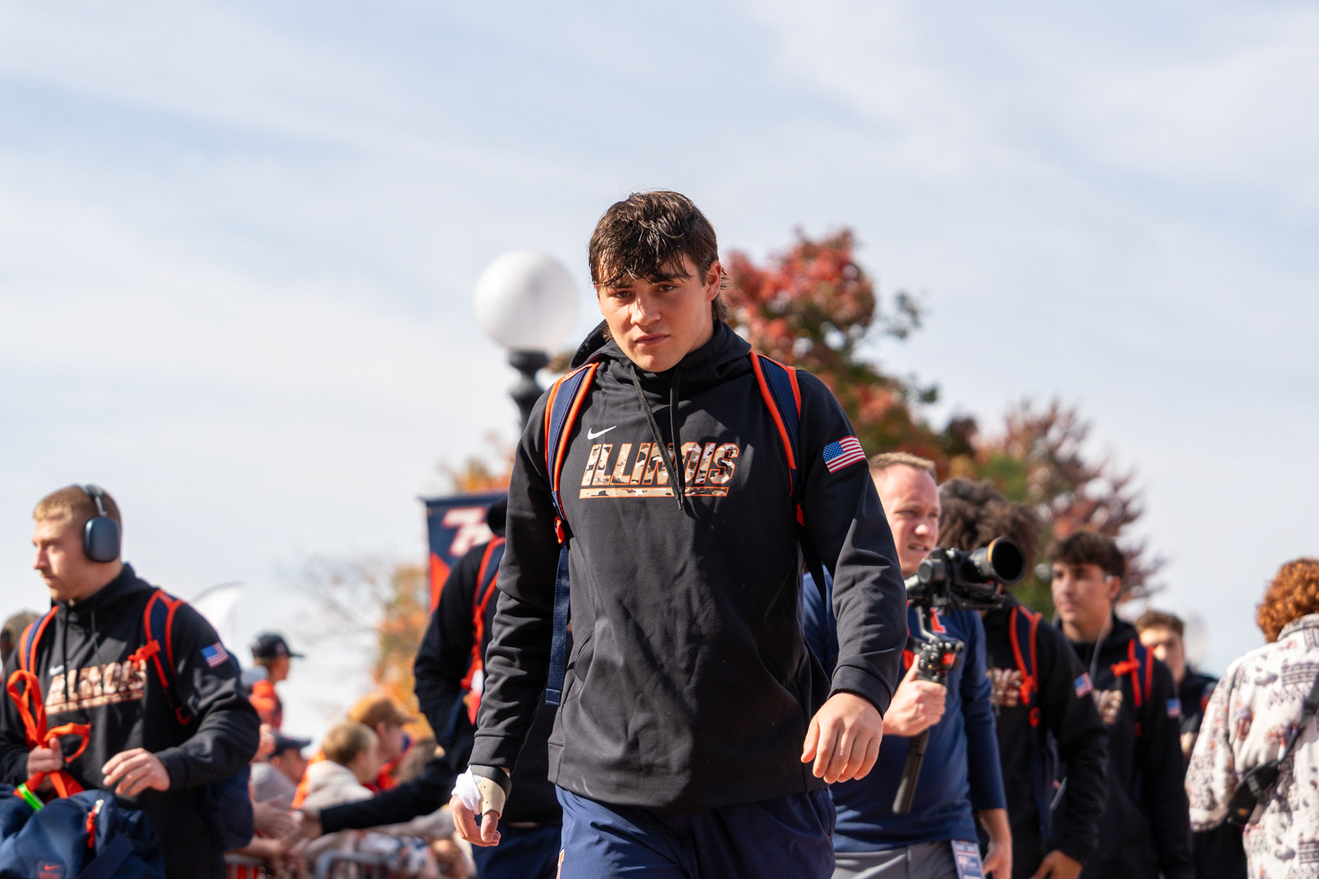 Illinois players walk through Grange Grove during the Illini Walk before their game against Oregon at Gies Memorial Stadium on Oct. 24, 2026. The Illini defeated the Ducks 21-10 in front of 58,723 fans.