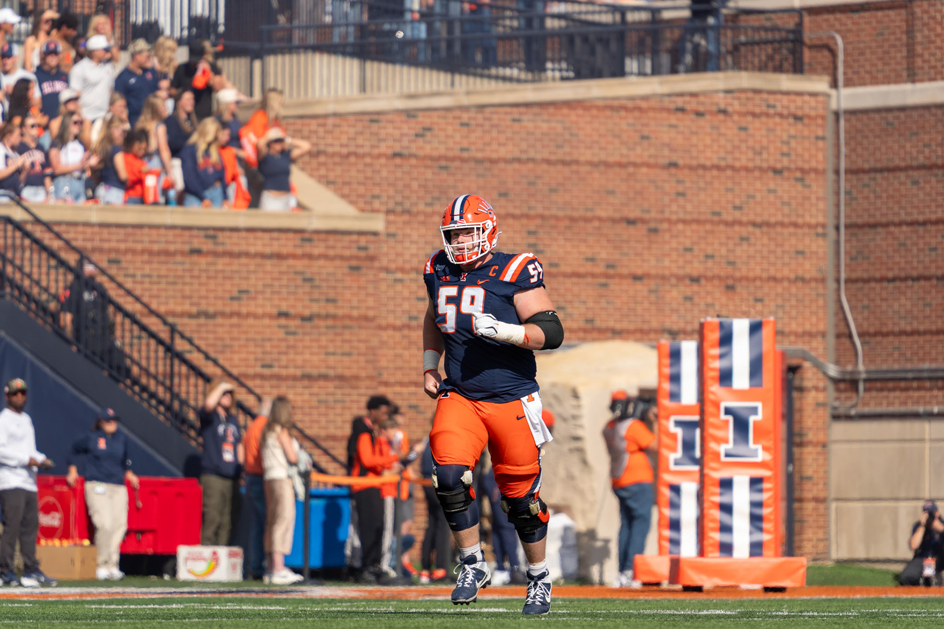 Jake Renfro, seventh-year offensive lineman, runs out of the tunnel before Illinois’ game against Oregon at Gies Memorial Stadium on Oct. 24, 2026. The Illini defeated the Ducks 21-10 to improve to 4-3 on the season.