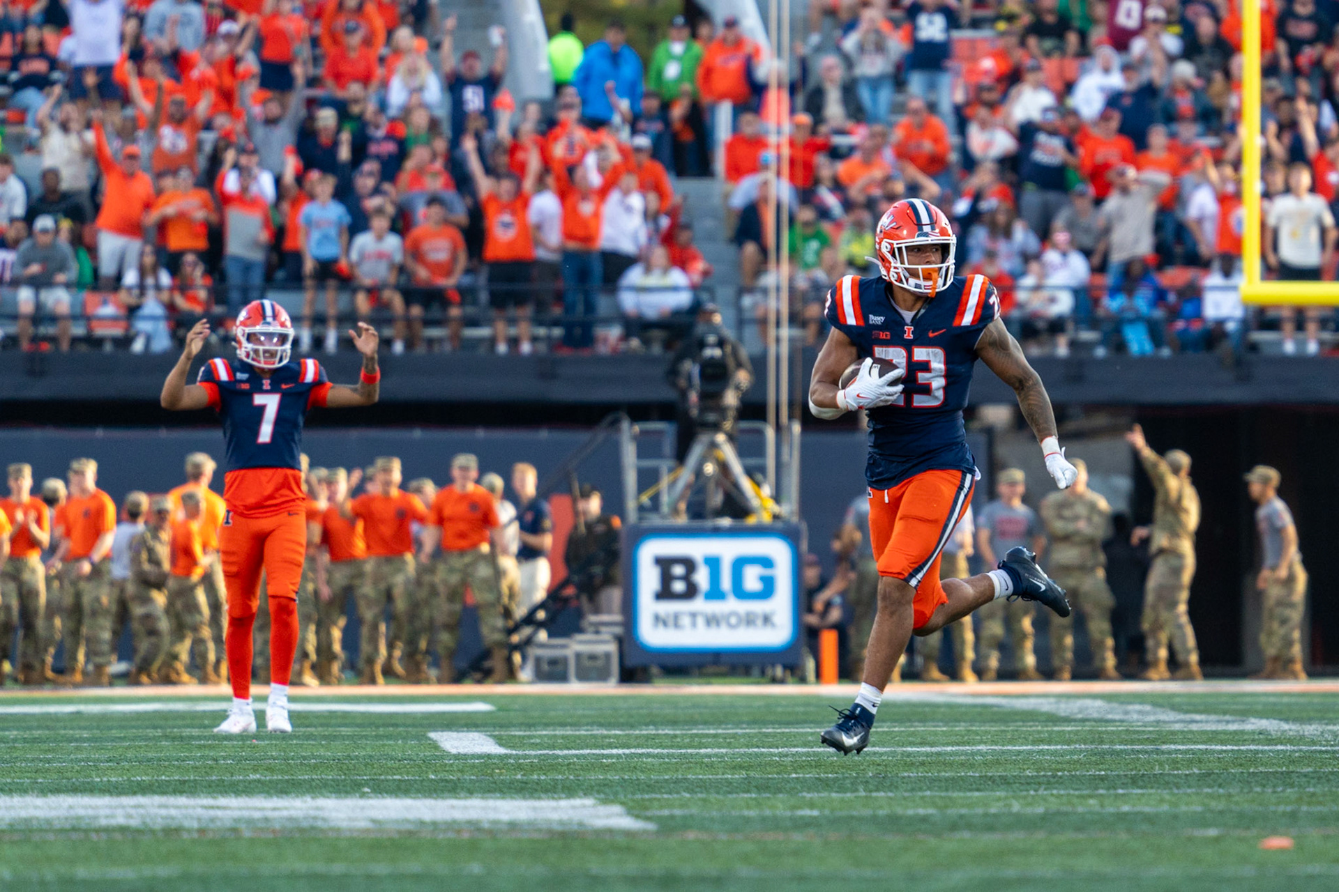 Jordan Anderson, fifth-year running back, breaks off a 33-yard run as quarterback Michael Clayton II celebrates in the background at Gies Memorial Stadium on Oct. 24, 2026. The run set up Illinois’ go-ahead touchdown drive in the fourth quarter of their 21-10 victory.