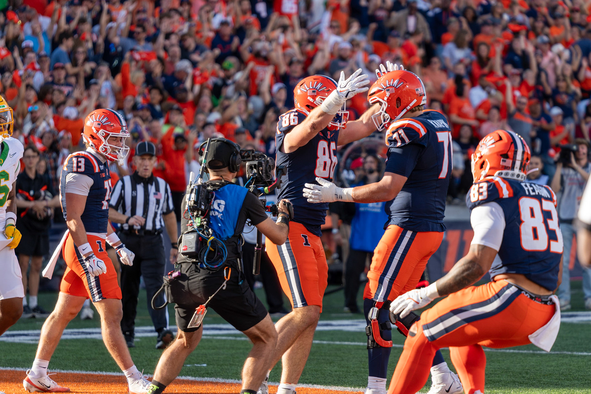 Christian Abney, senior tight end, celebrates his touchdown reception with offensive lineman Nathan Knapik and tight end Kaden Feagin at Gies Memorial Stadium on Oct. 24, 2026. The 9-yard score in the third quarter gave Illinois a 14-10 lead over Oregon.