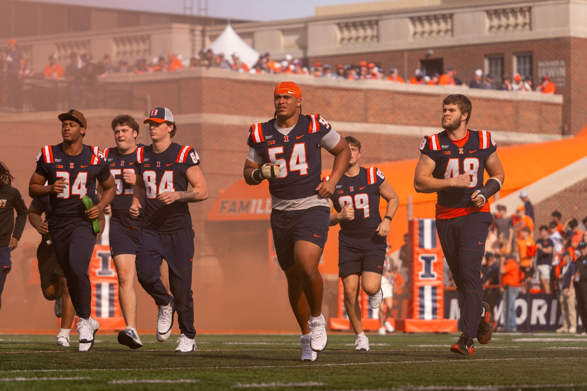 Illinois football players run out of the tunnel before their game against Oregon at Gies Memorial Stadium on Oct. 24, 2026. The Illini defeated the Ducks 21-10 in front of 58,723 fans.