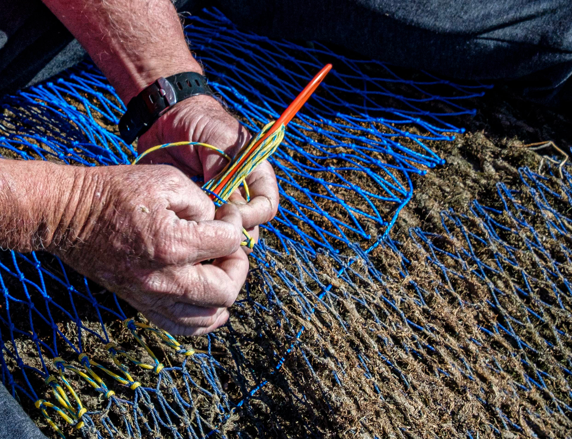 Mending fishing nets
