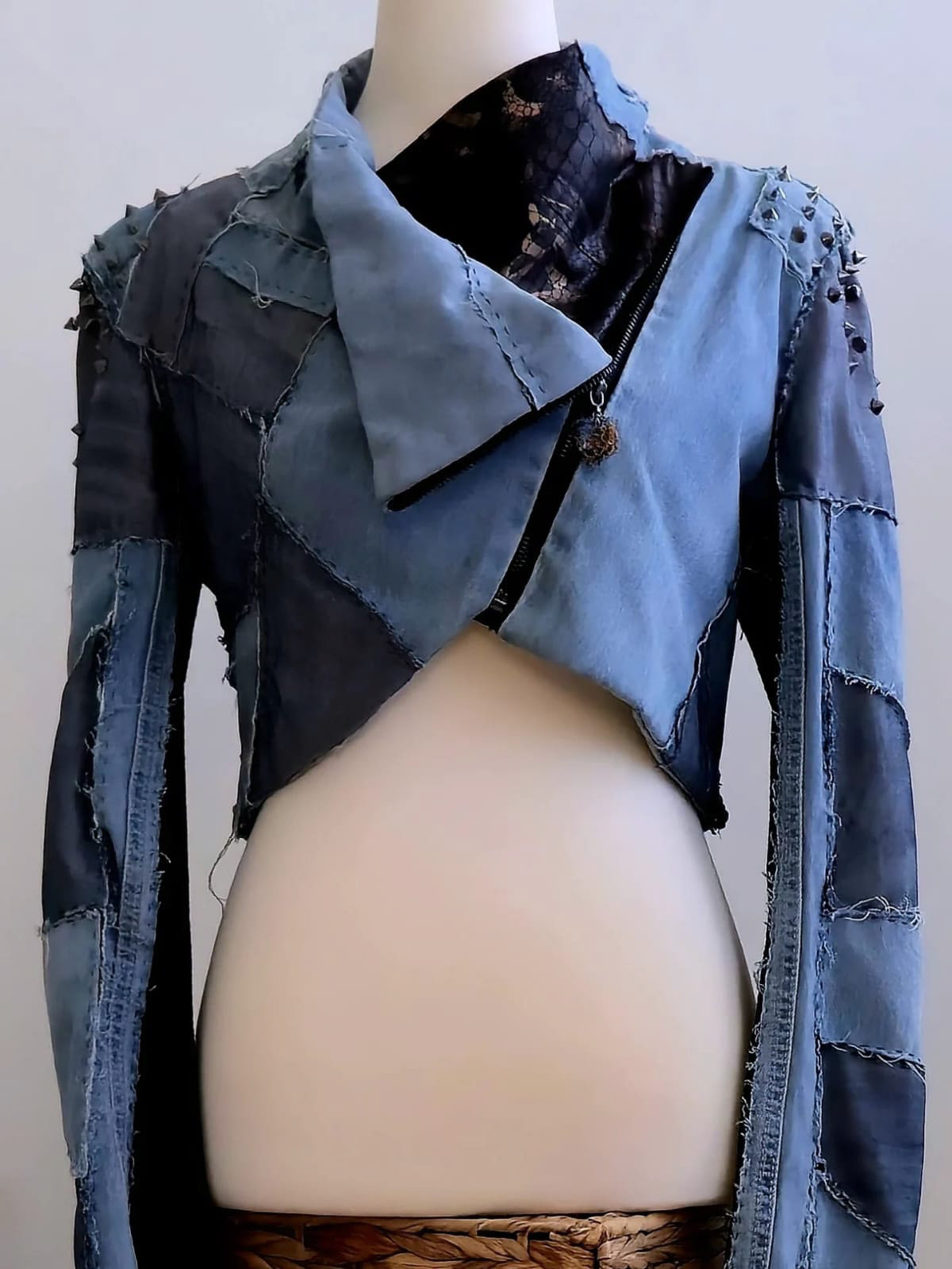 The second upcycled jacket — black leather reborn into denim, spikes, and stitched strength.
