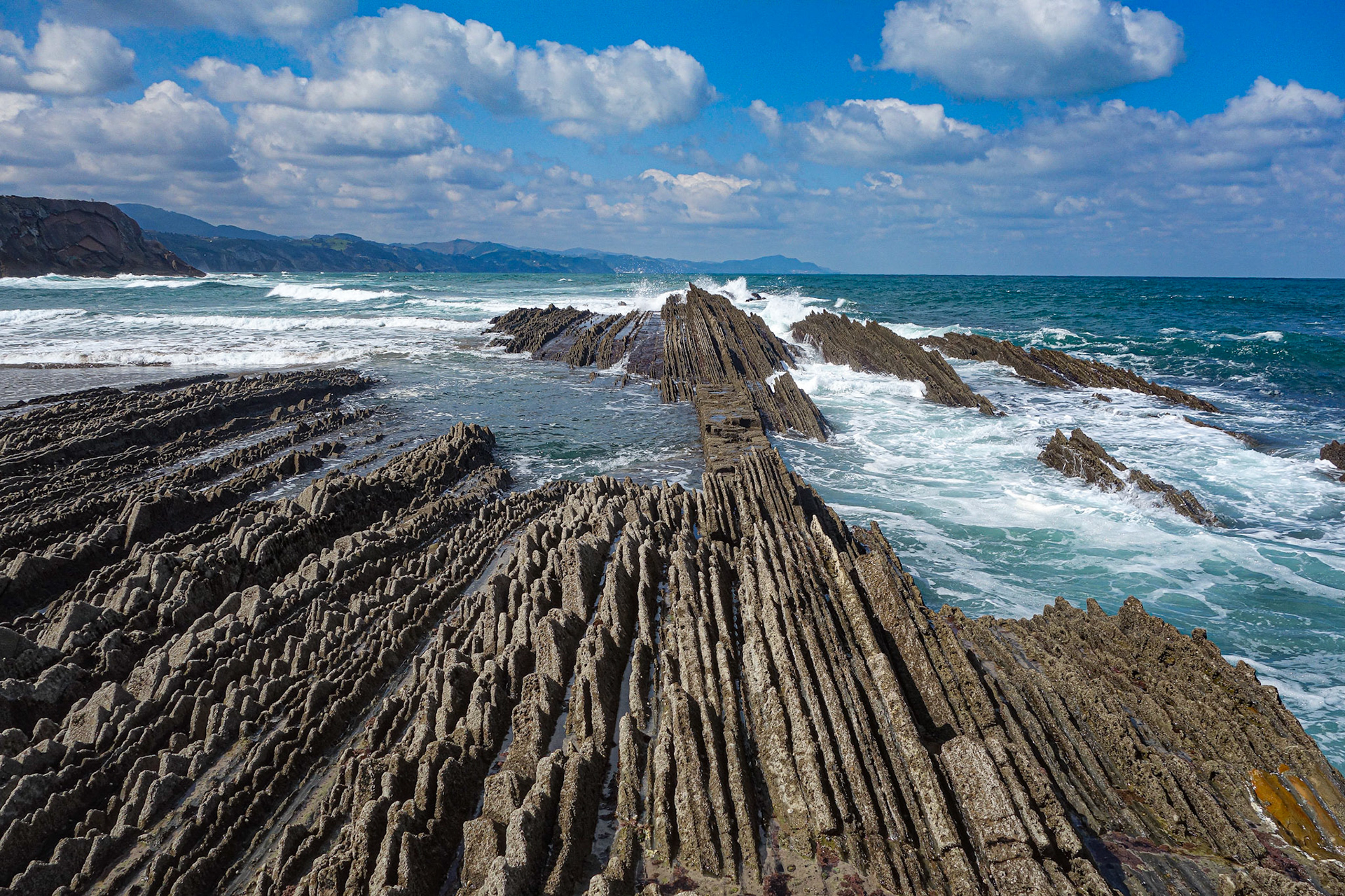 Zumaia, Spain - March 17, 2021: Flysch rock formations on the beach in Zumaia, Basque Country, Spain