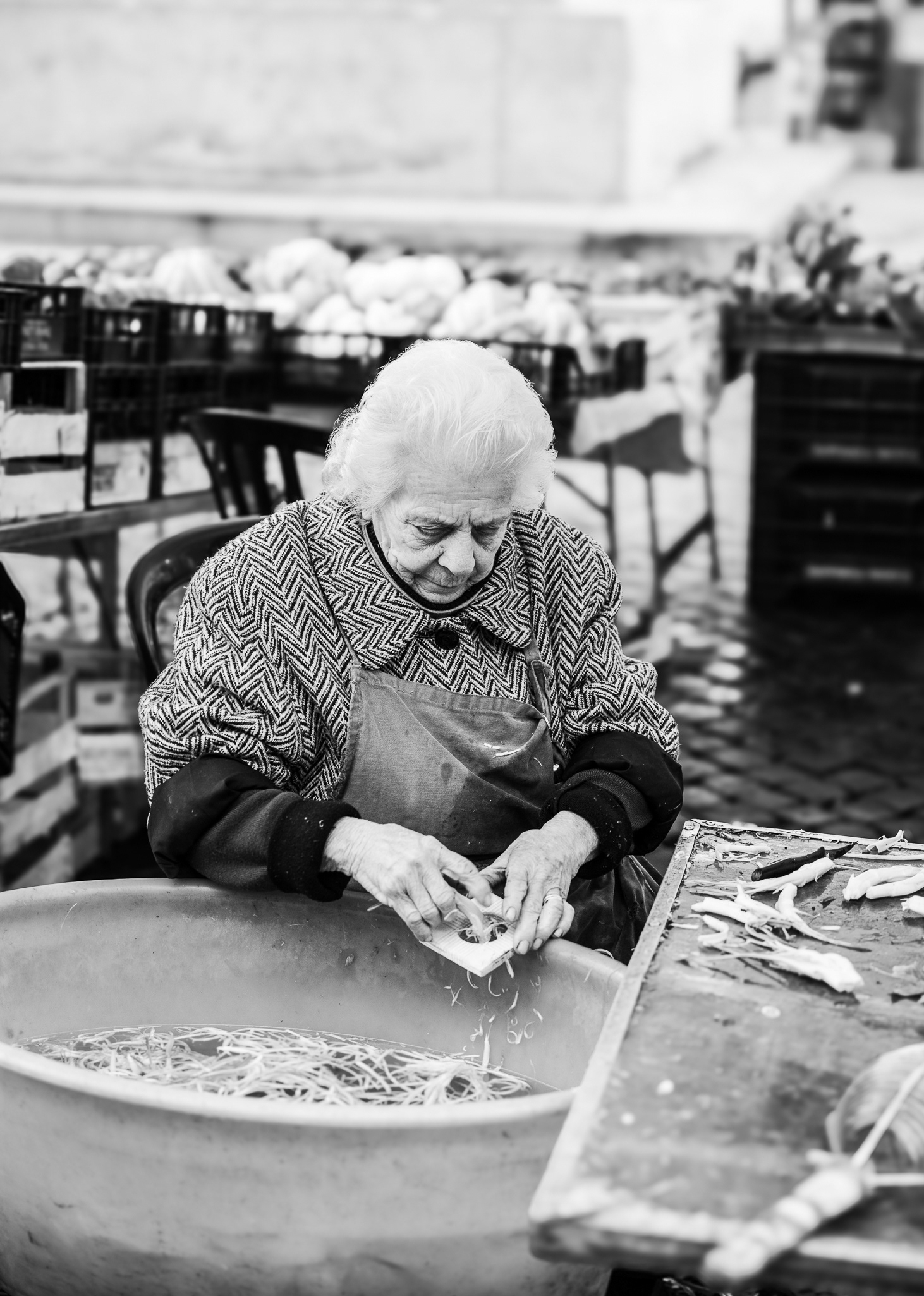Woman in a market working with puntarelle