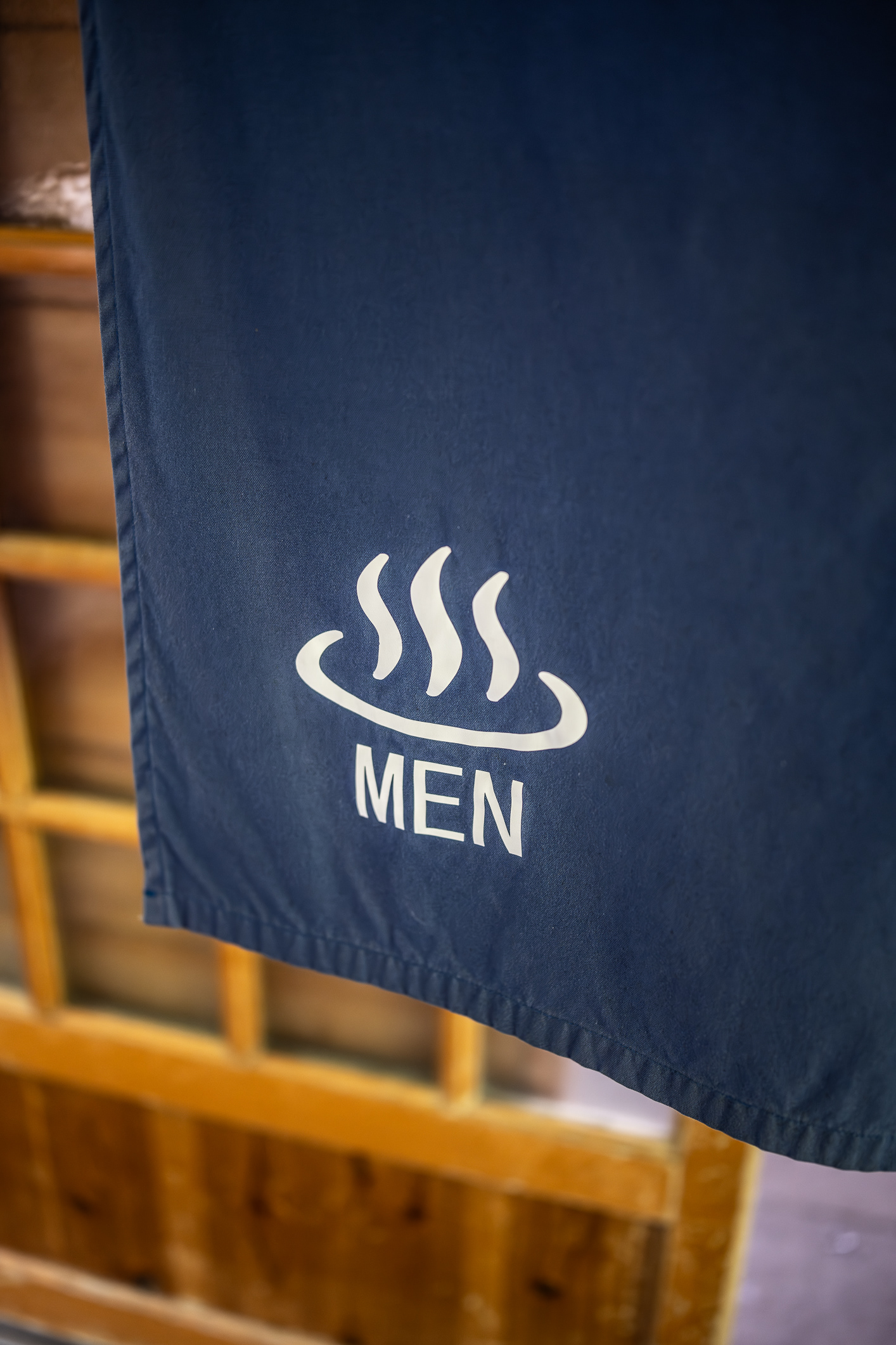 The blue noren showing the entrance to men's bathing room at Takaragawa Onsen