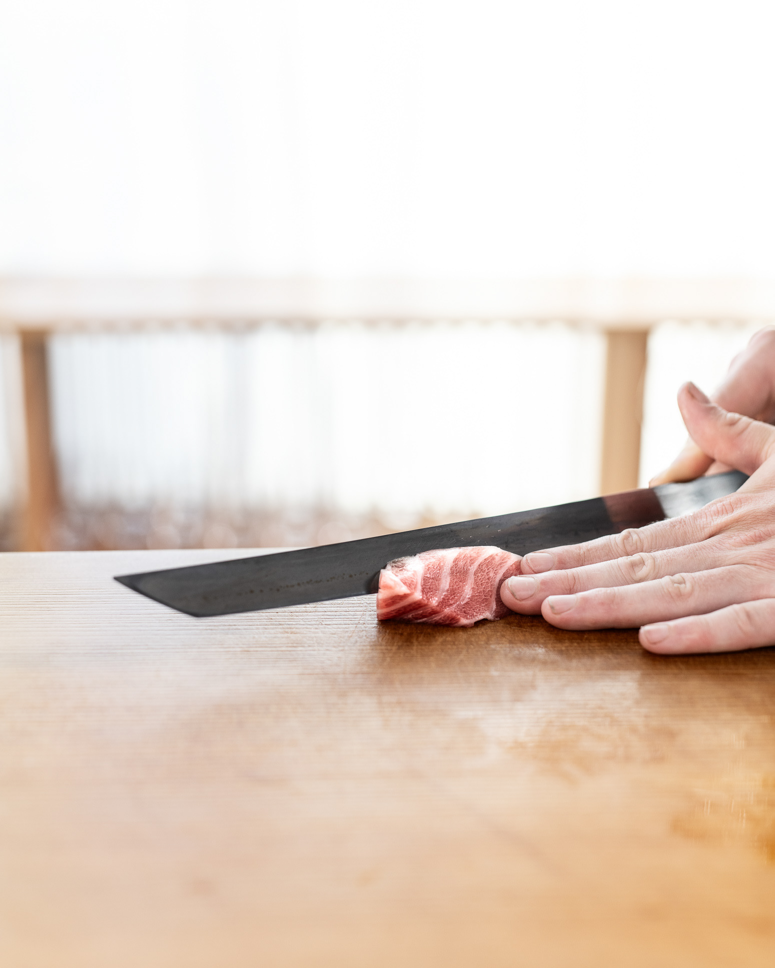 Mads Battefeld cutting fish for sashimi - at Sushi Anaba