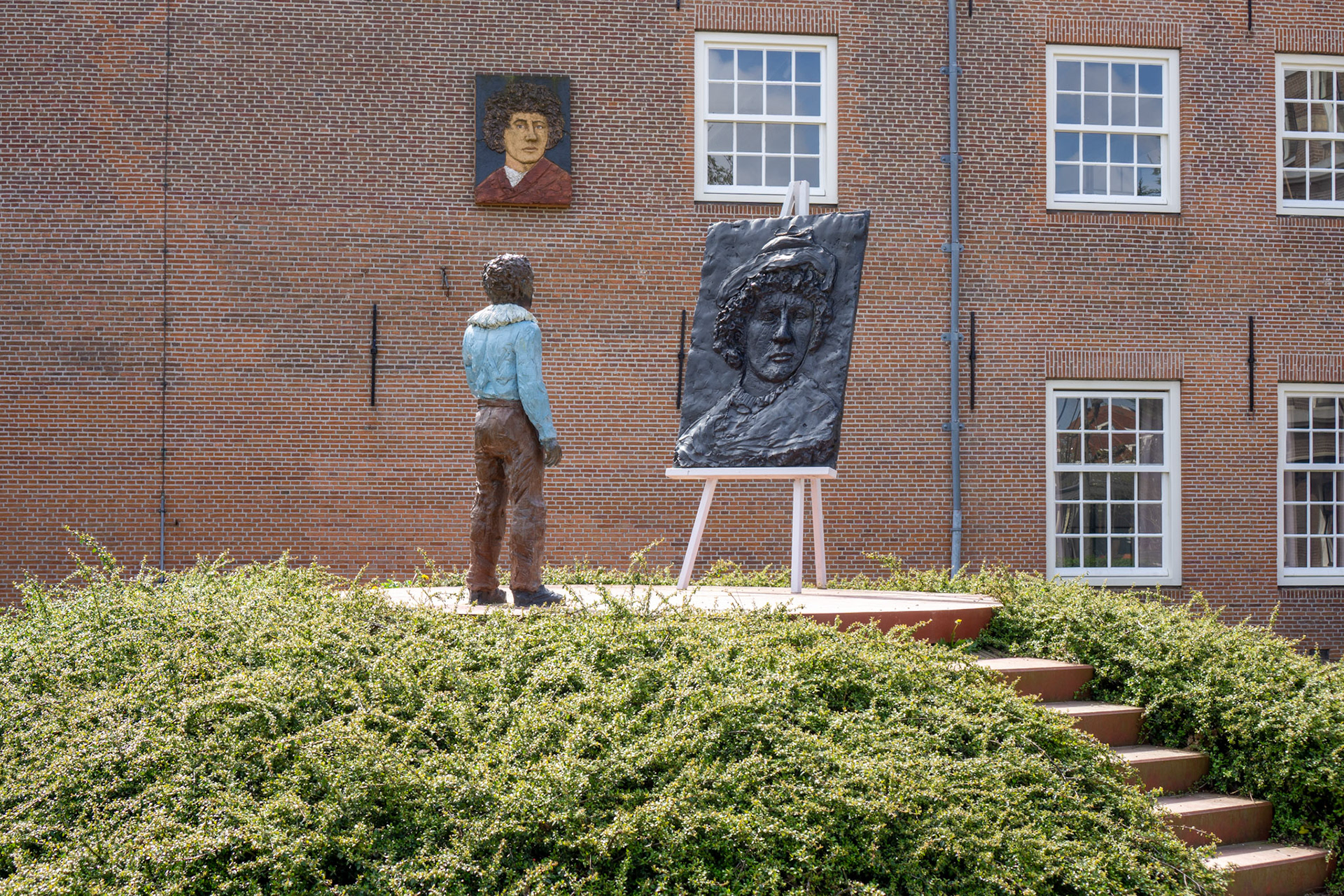 Statue of a young Rembrandt painting a self-portrait at his birthplace.