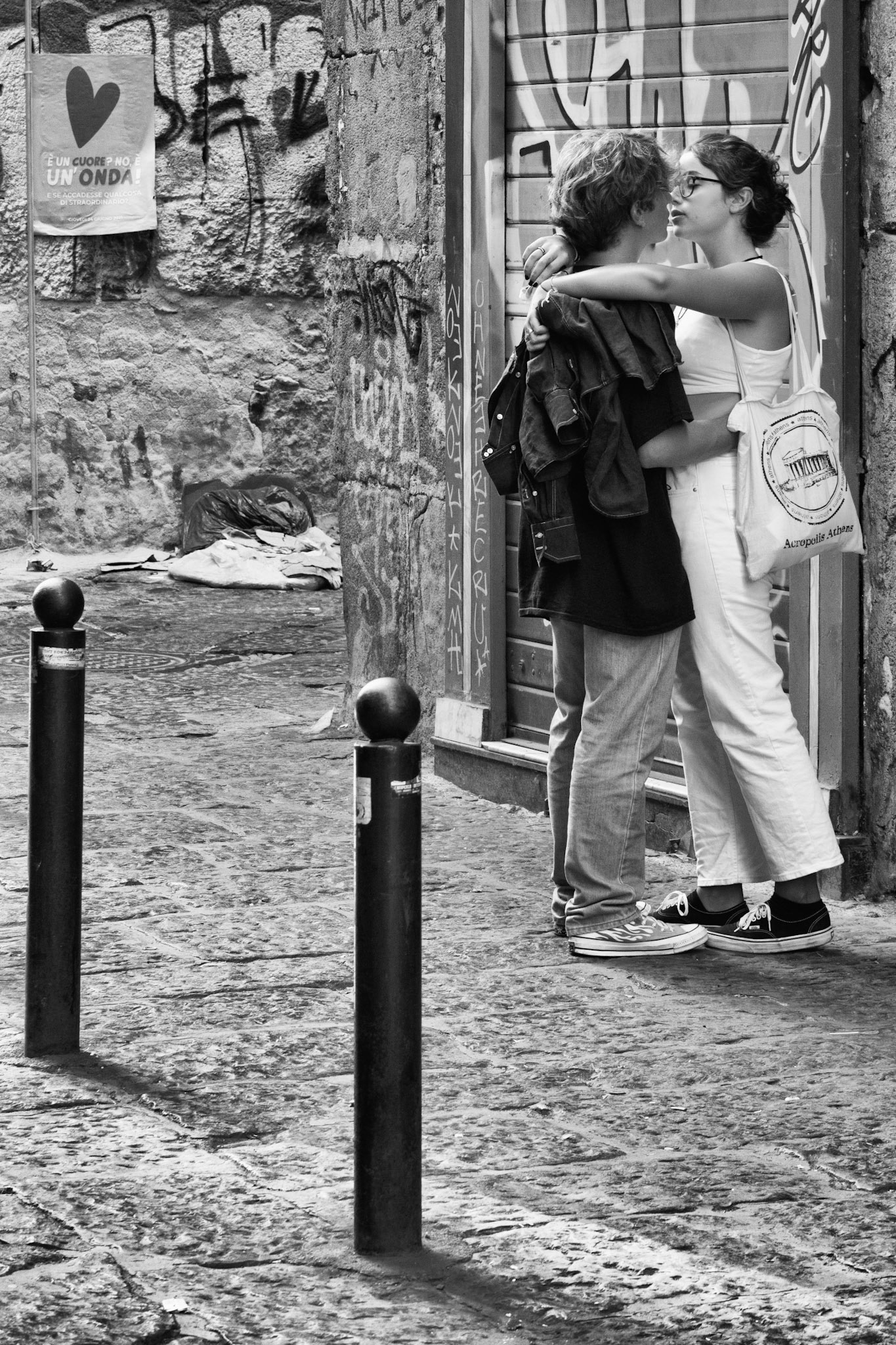 It's called "Kisses #3" because it's the third photo of a series where the main theme is the kiss. I took photos of kisses in Italy and I took this photo while I walked through the streets of Naples (Italy). In my perspective, what makes it special is the flyer with the heart in the background.
