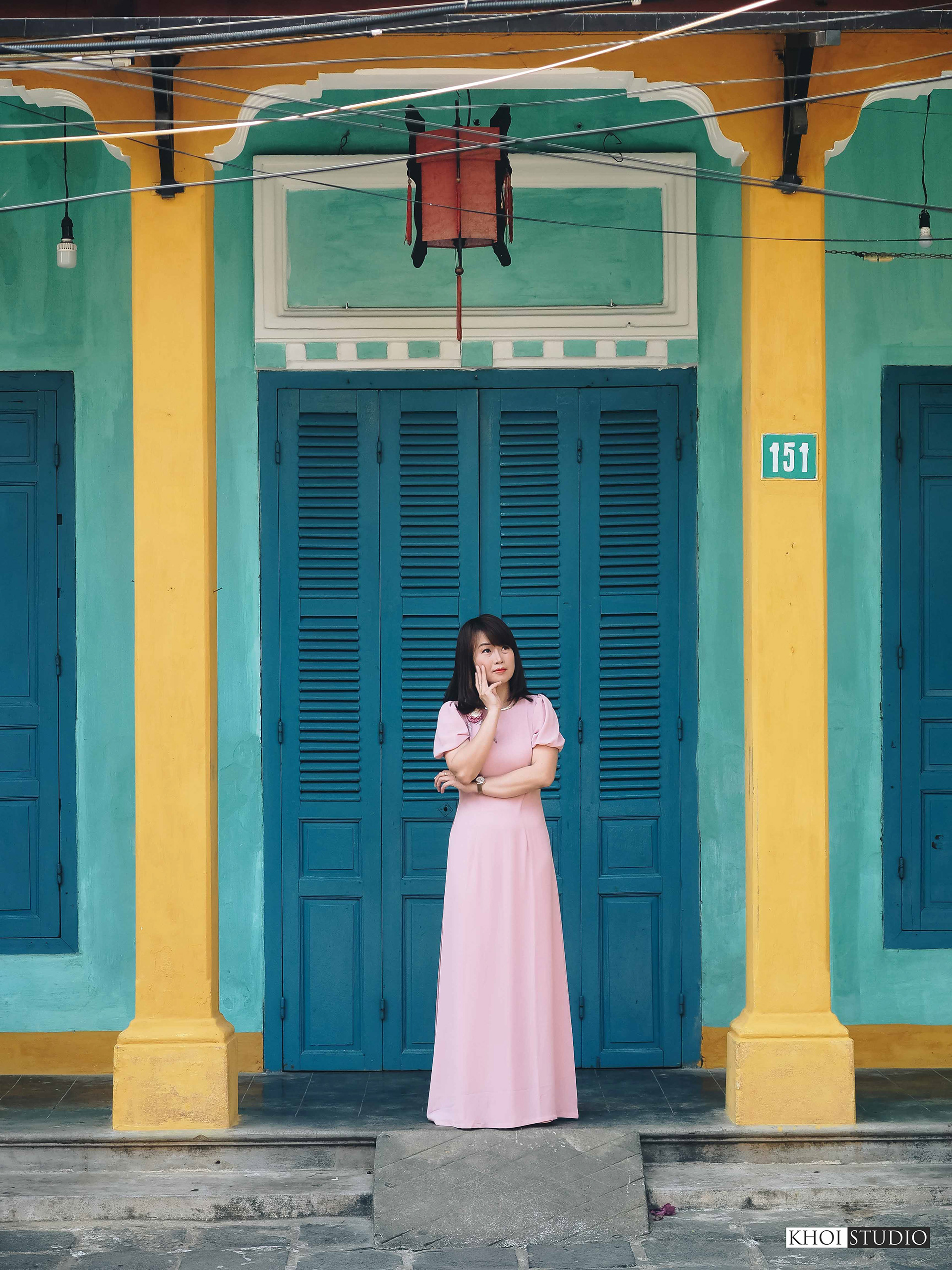 Female tourists are modeling for a photo shoot in Ao Dai in the summer in Hoi An.