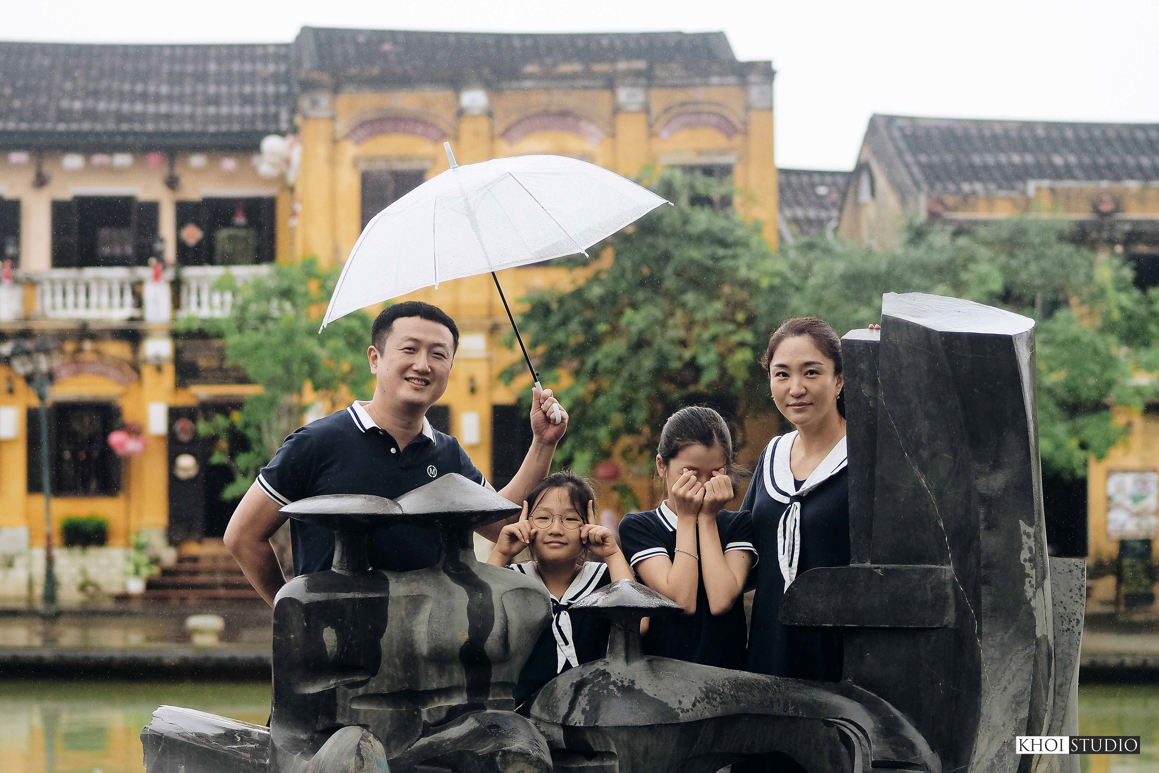 Family together on a rainy day in Hoi An ancient town | Tourist from South Korea