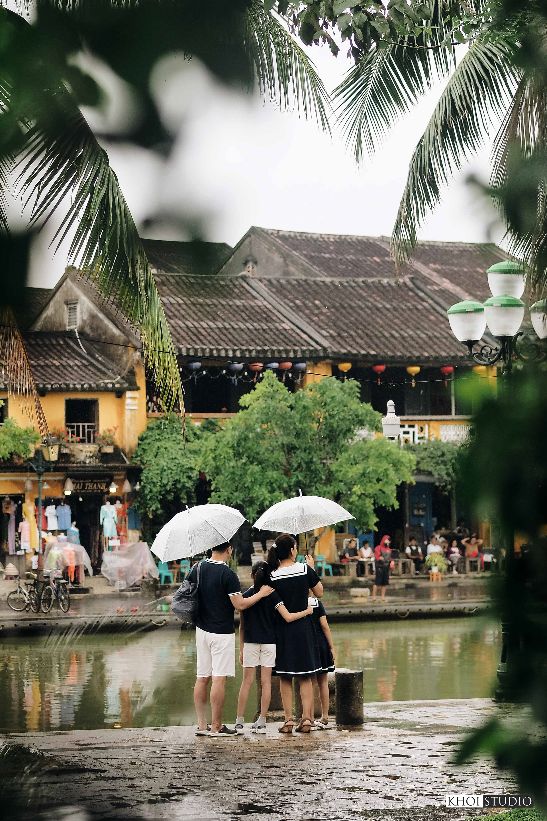 Family together on a rainy day in Hoi An ancient town | Tourist from South Korea